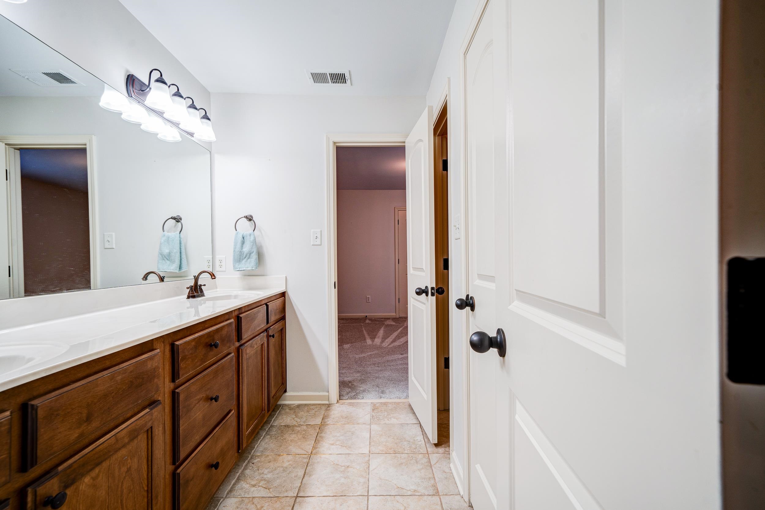 Bathroom featuring vanity and tile patterned flooring