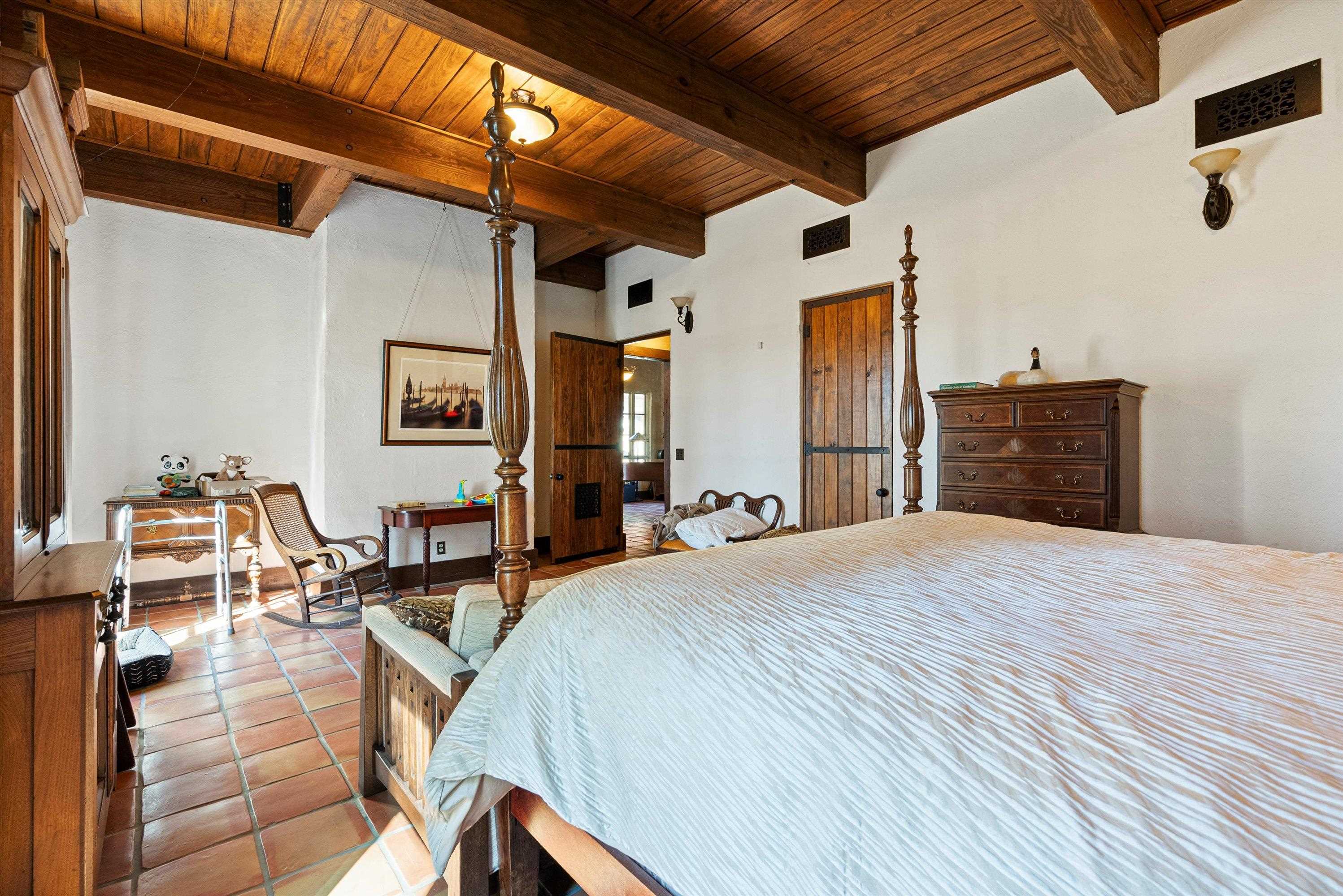 Tiled bedroom with beam ceiling and wooden ceiling