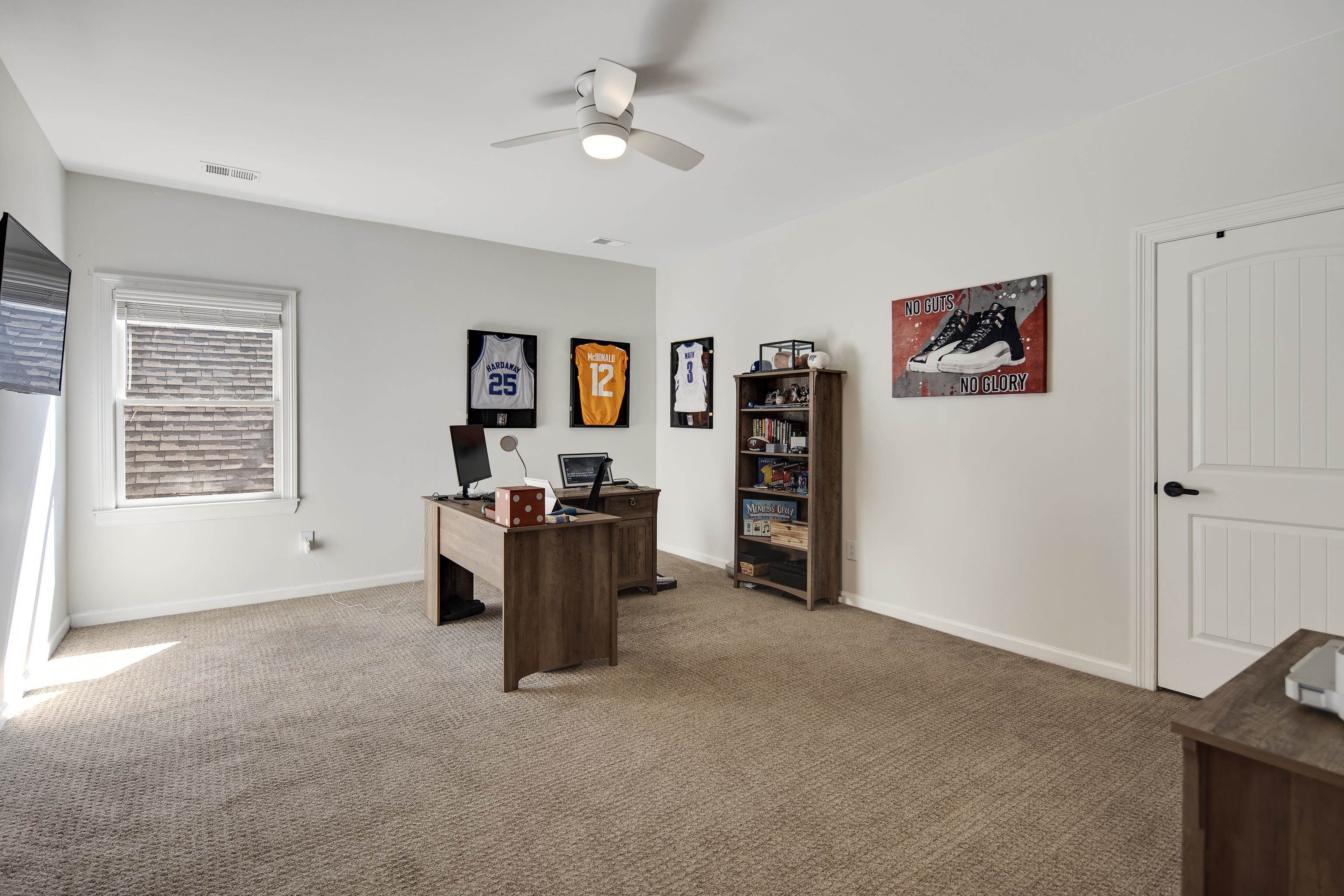 Carpeted office with ceiling fan