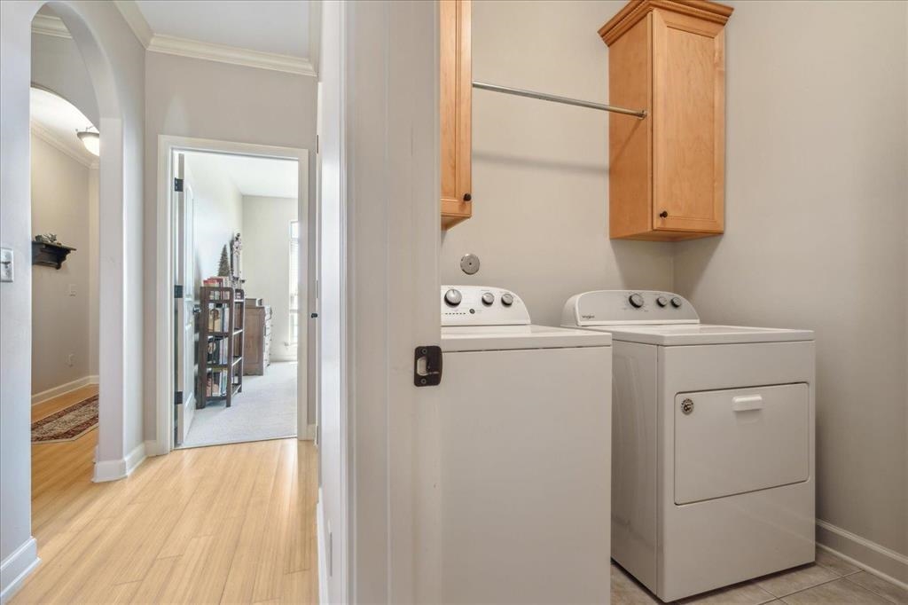 Laundry room with extra storage. Washer and dryer to remain with home.