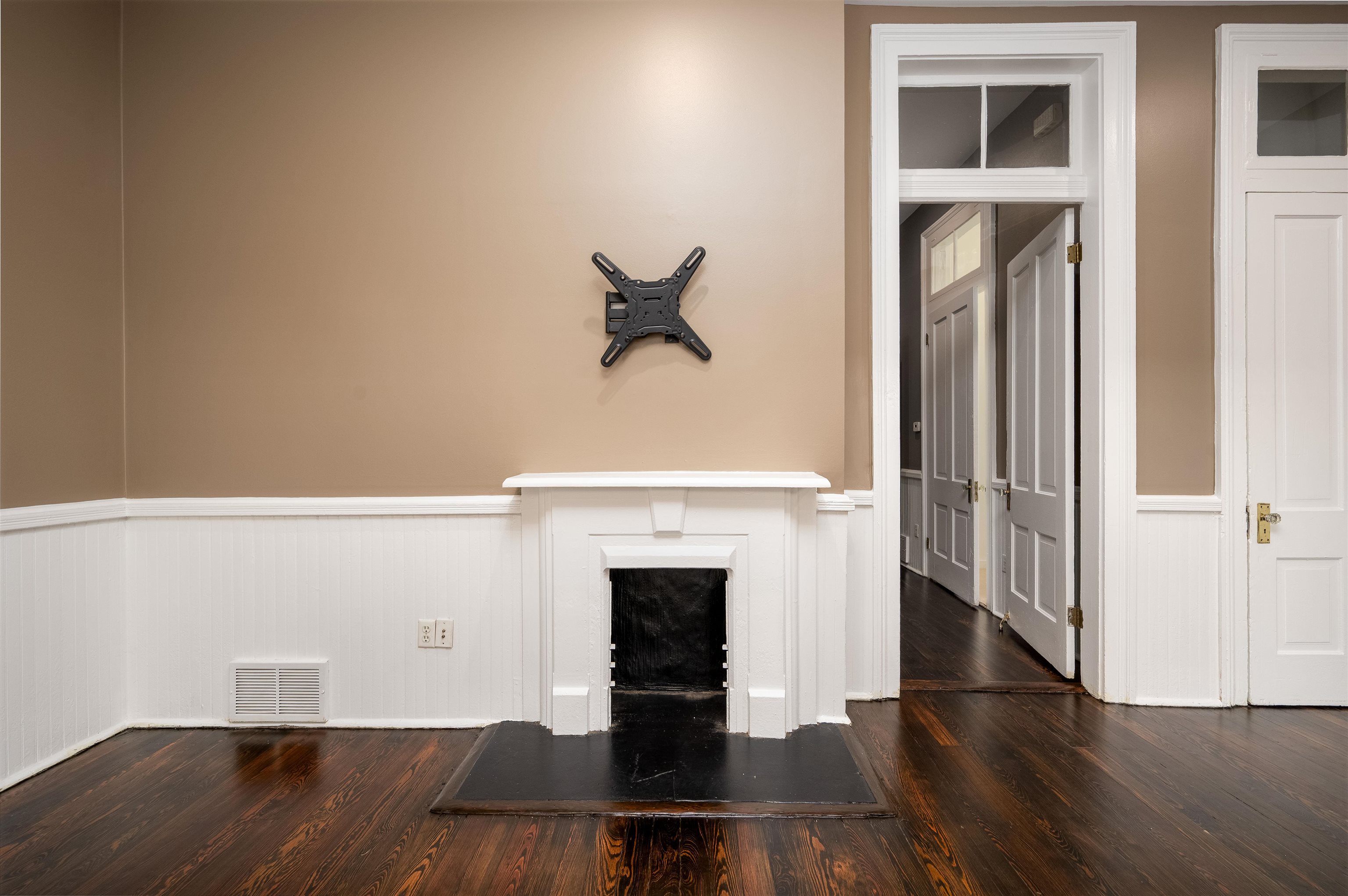 Unfurnished living room with dark wood-type flooring