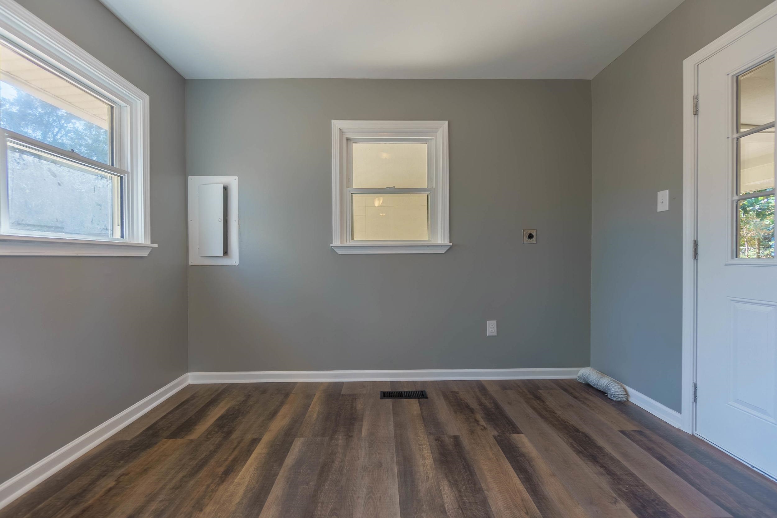 Empty room with dark hardwood / wood-style flooring