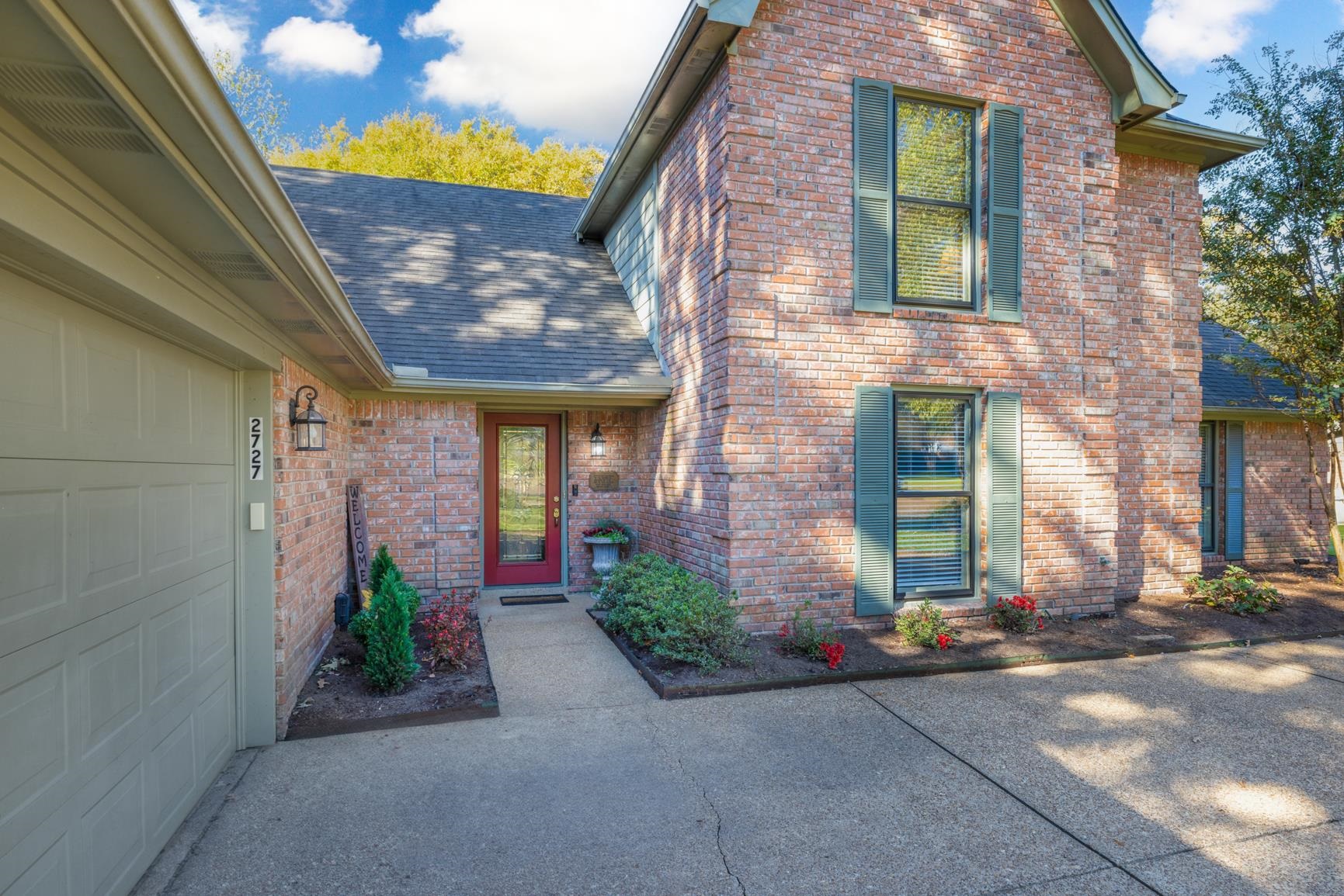 View of exterior entry with a garage