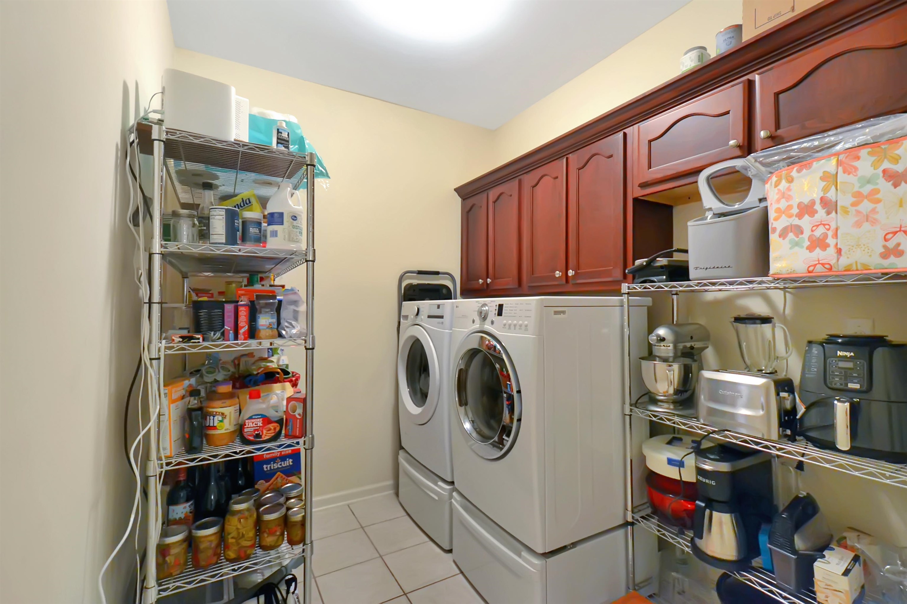 Spacious laundry with room for an extra refrigerator.  There is a pantry located behind the door in the room as well.