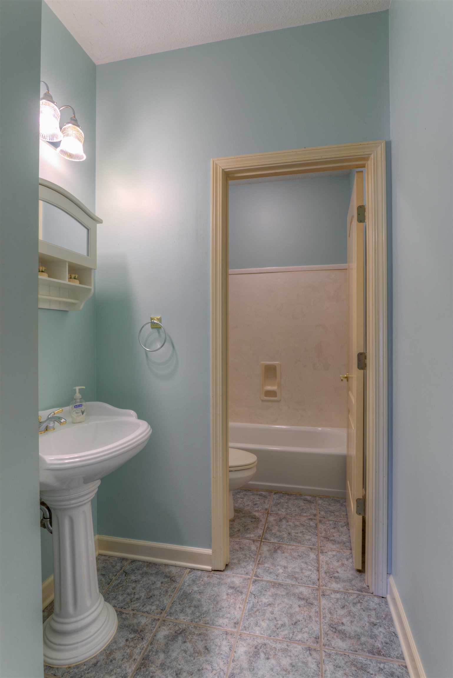 Bathroom featuring toilet, a textured ceiling, shower / bath combination, and tile patterned flooring