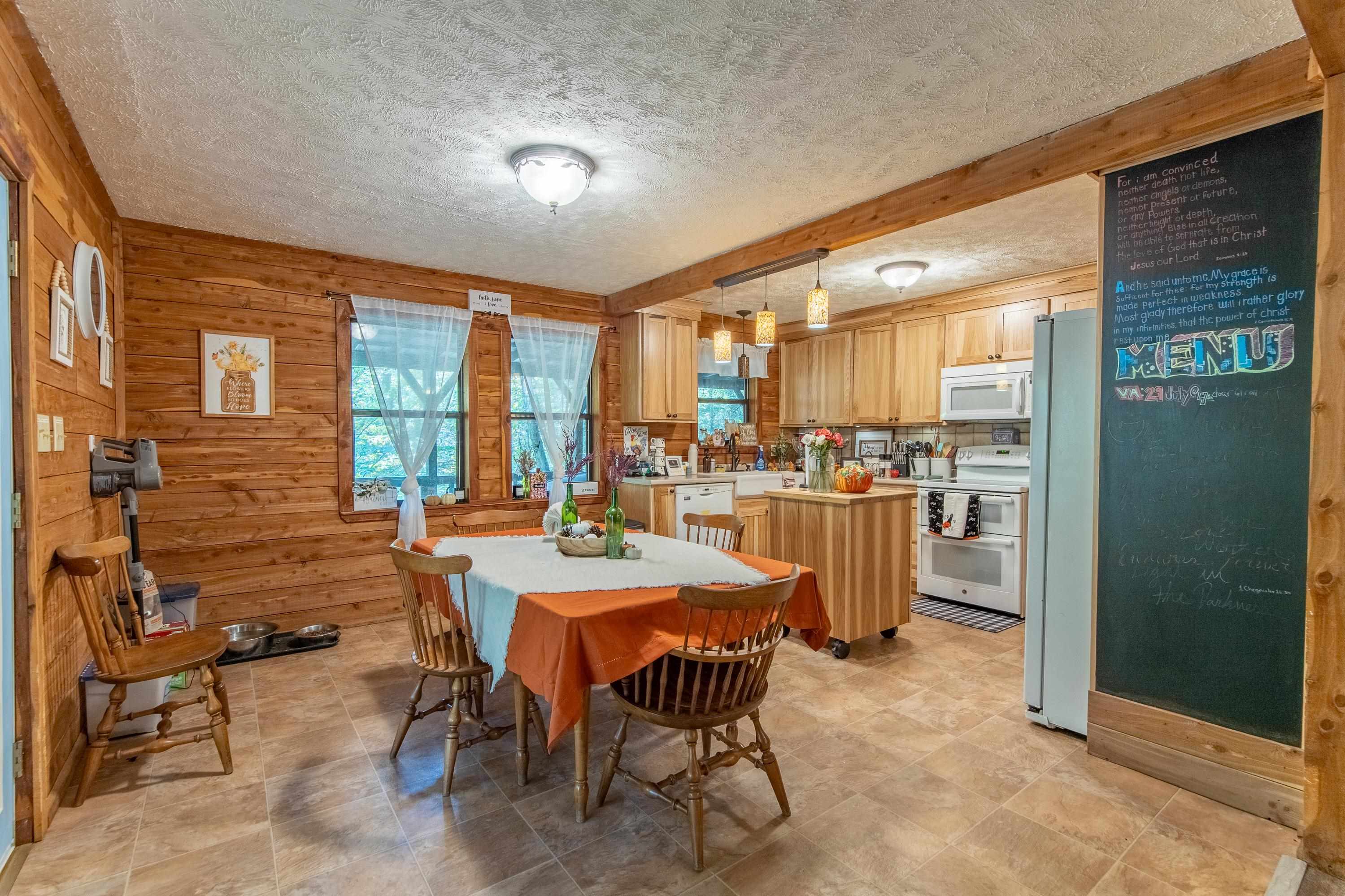 Dining space with wood walls and a textured ceiling