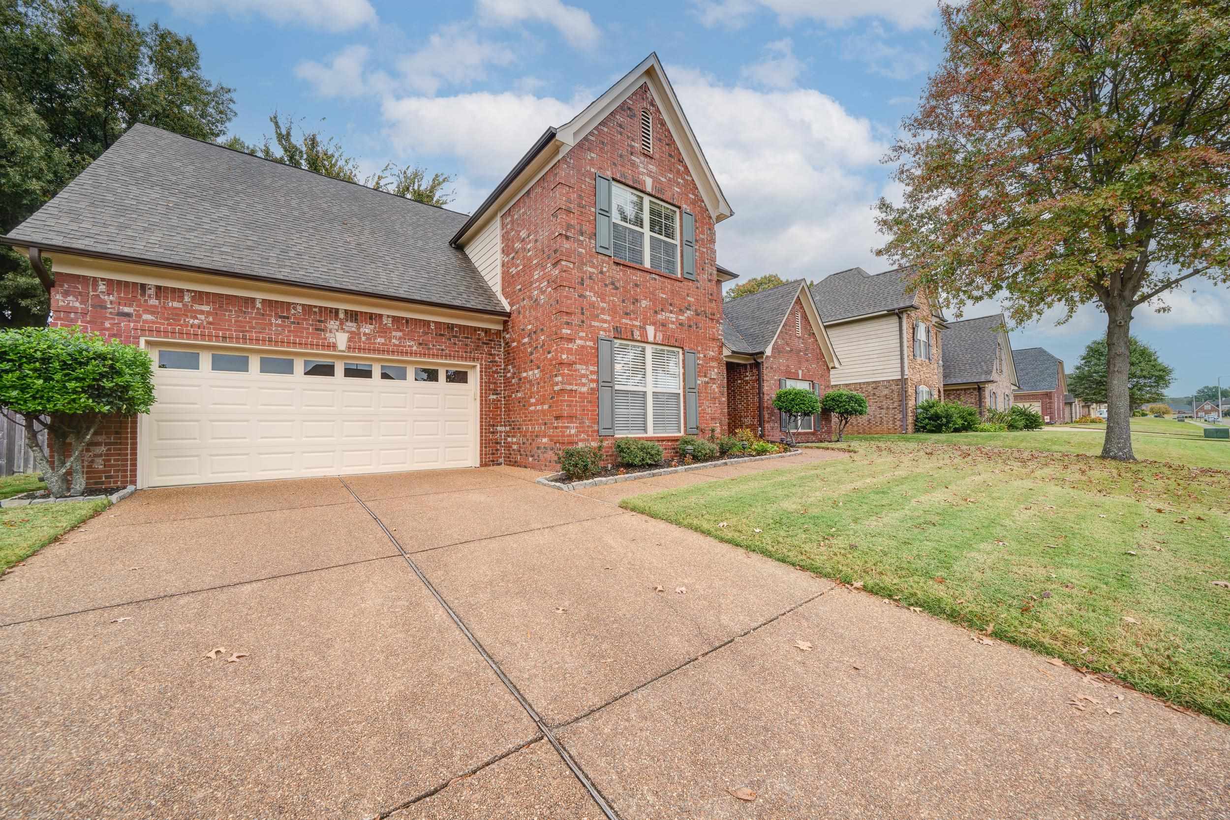 View of front property with a front yard and a garage