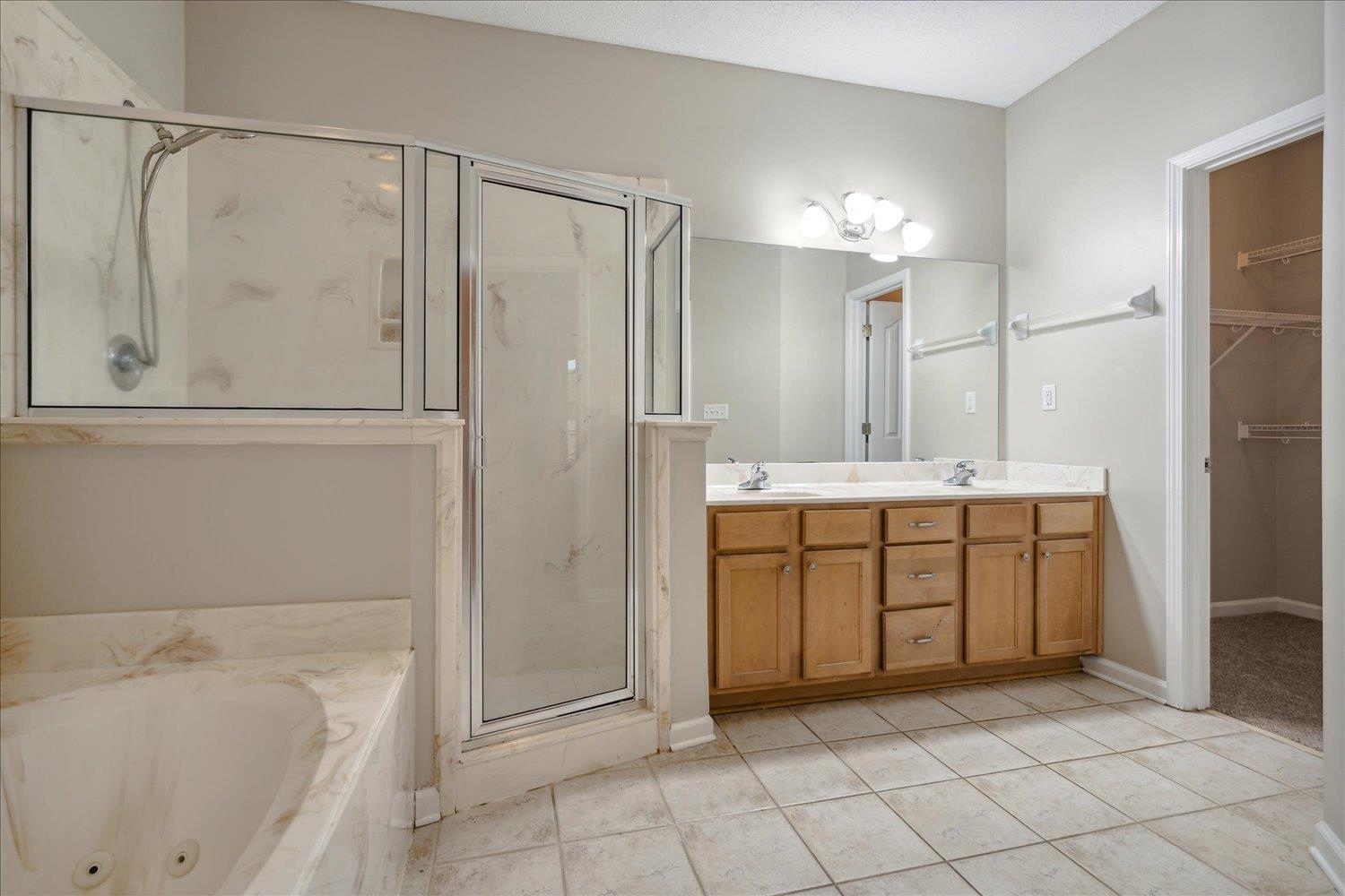 Bathroom featuring vanity, tile patterned floors, and independent shower and bath