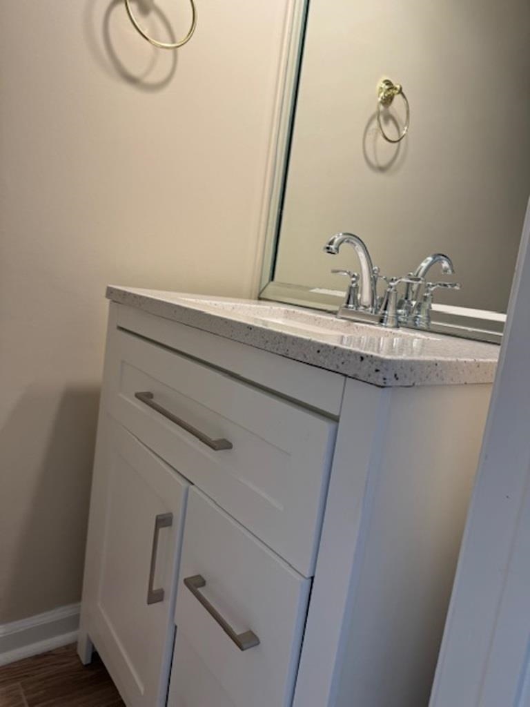 Bathroom with vanity and hardwood / wood-style floors