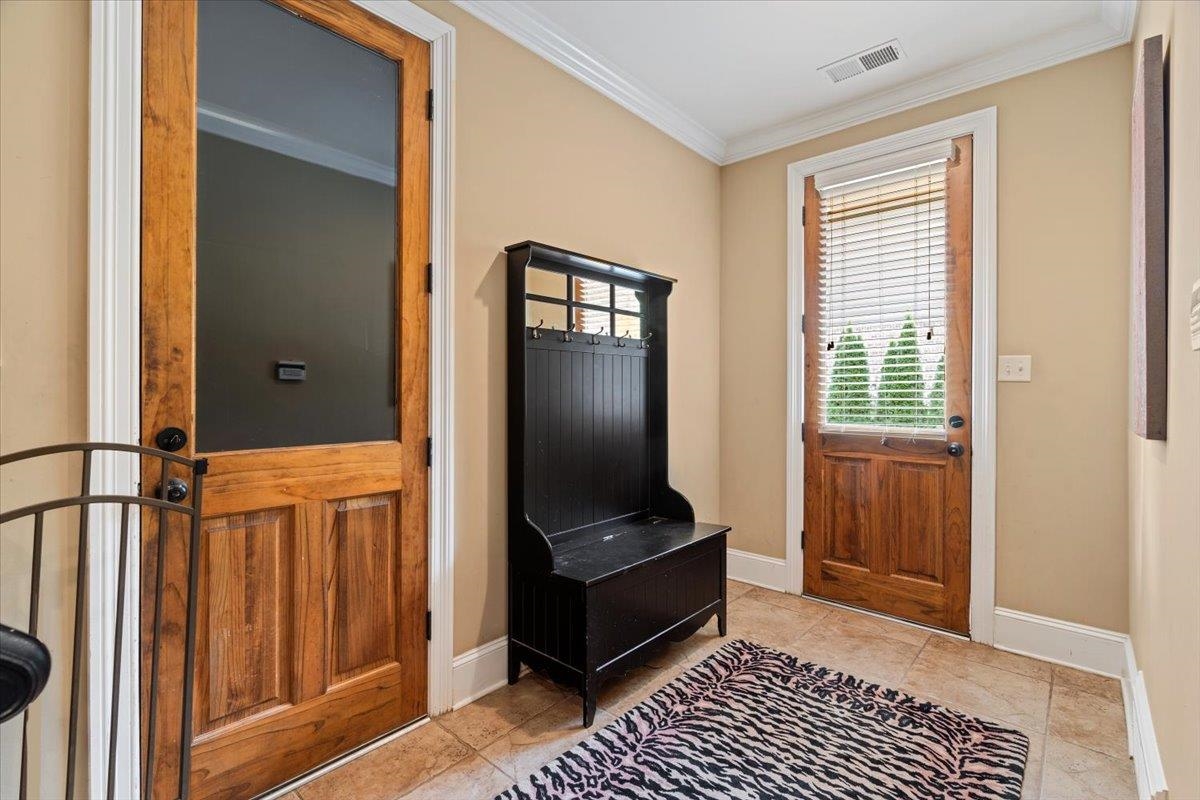 Entryway featuring crown molding