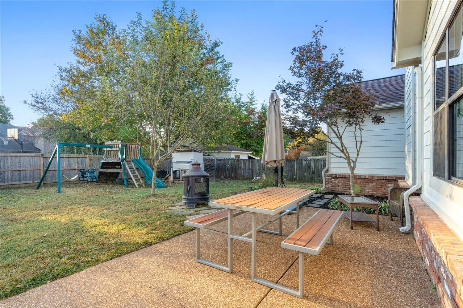 View of patio / terrace featuring a storage shed and a playground