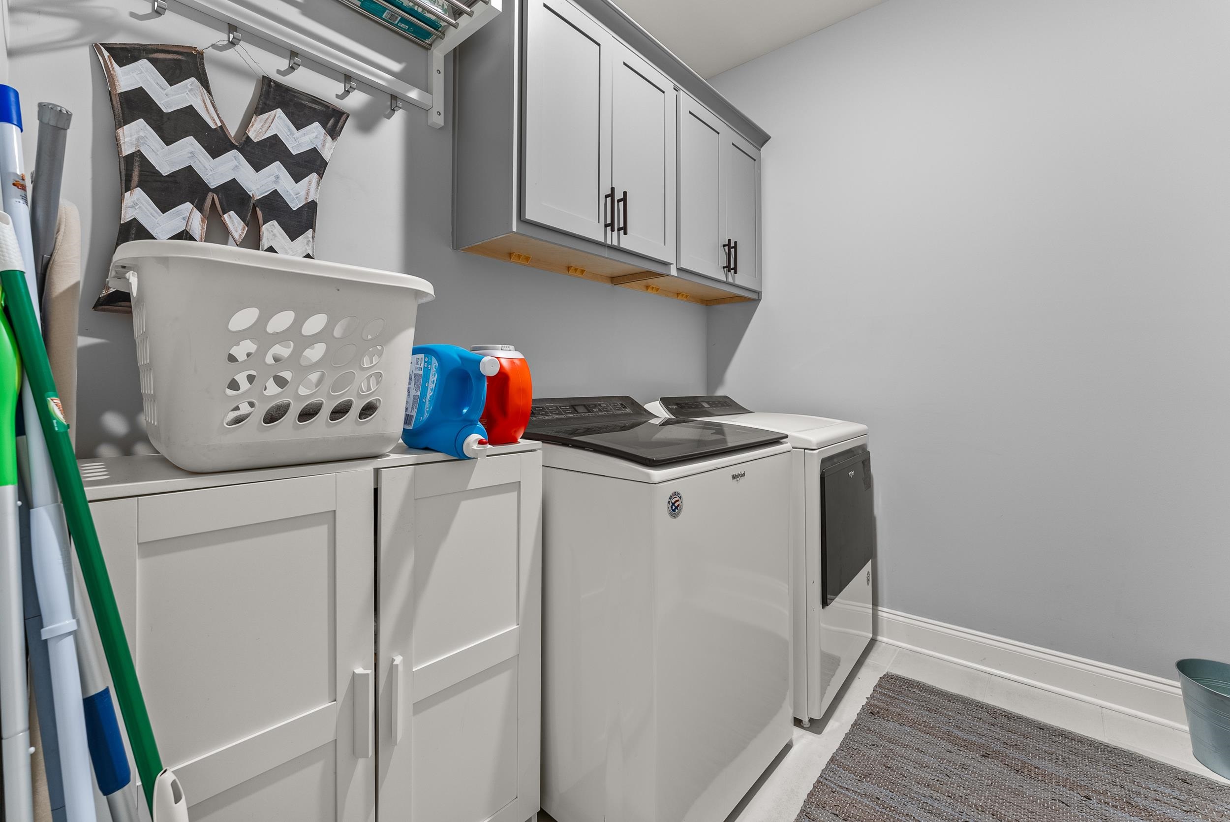 Laundry room with cabinets and washer and dryer