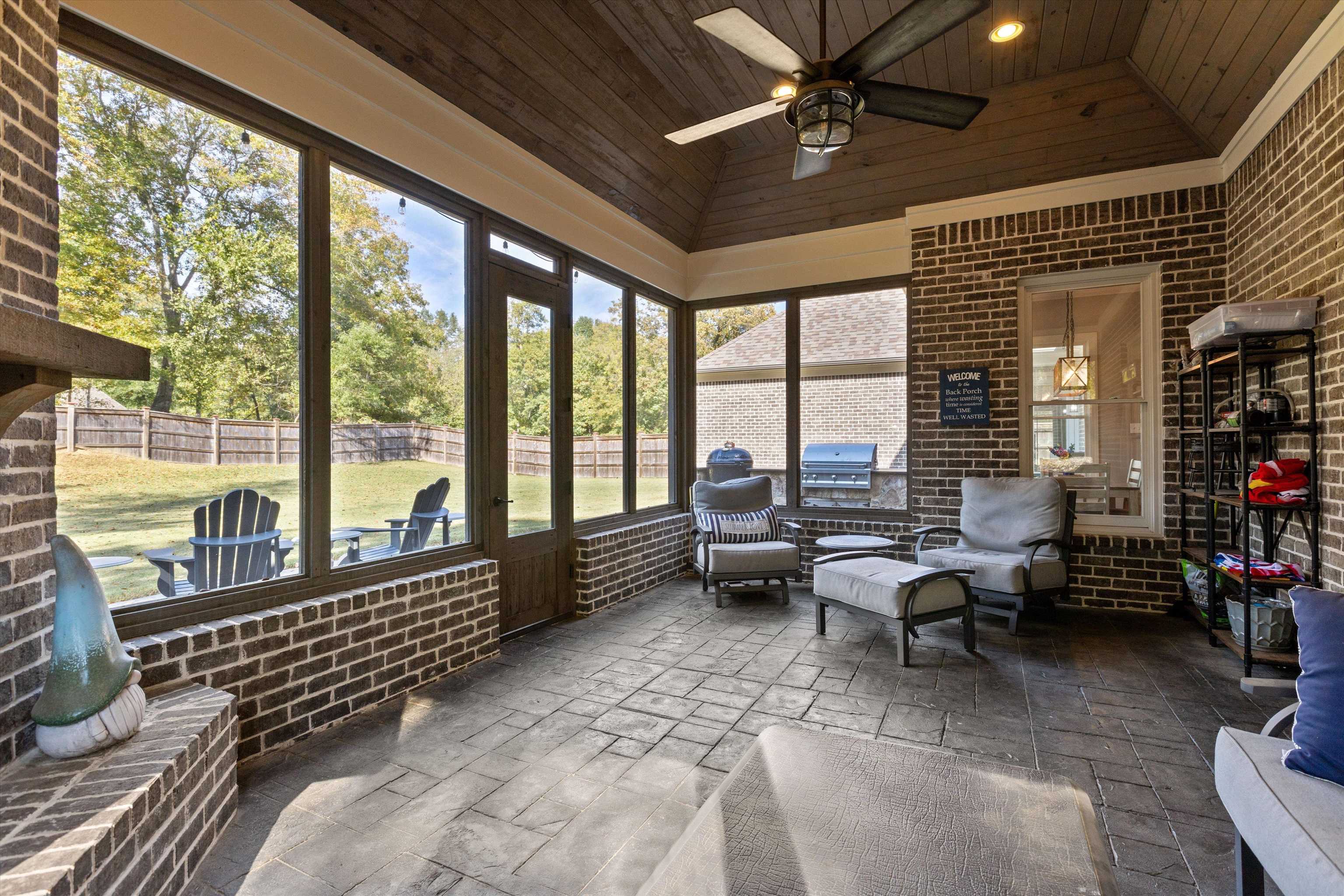 Sunroom / solarium with lofted ceiling, wood ceiling, and ceiling fan