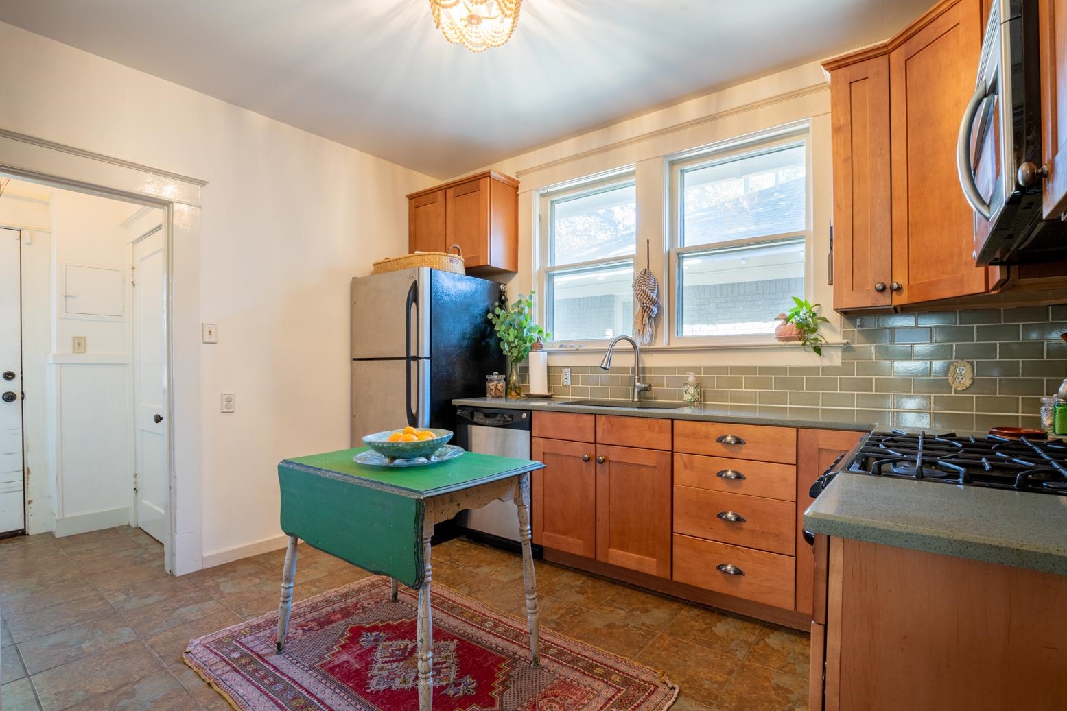 Kitchen with backsplash, stainless steel appliances, and sink