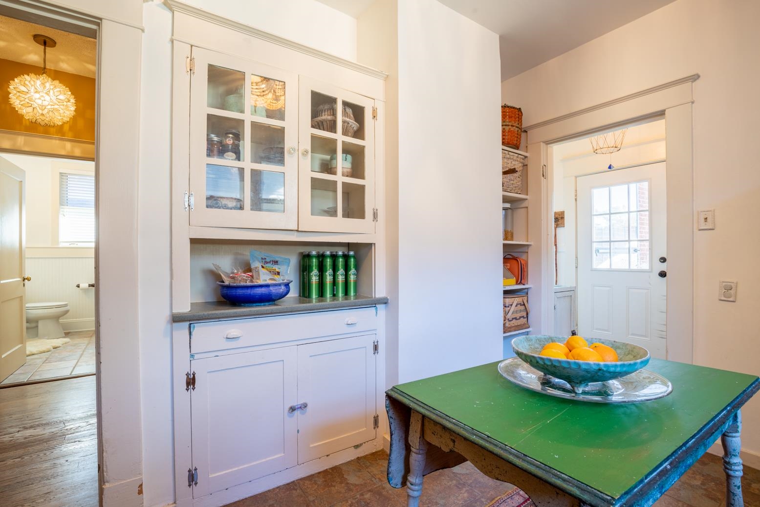 Opposite view shows built-in butlers pantry with glass front cabinets