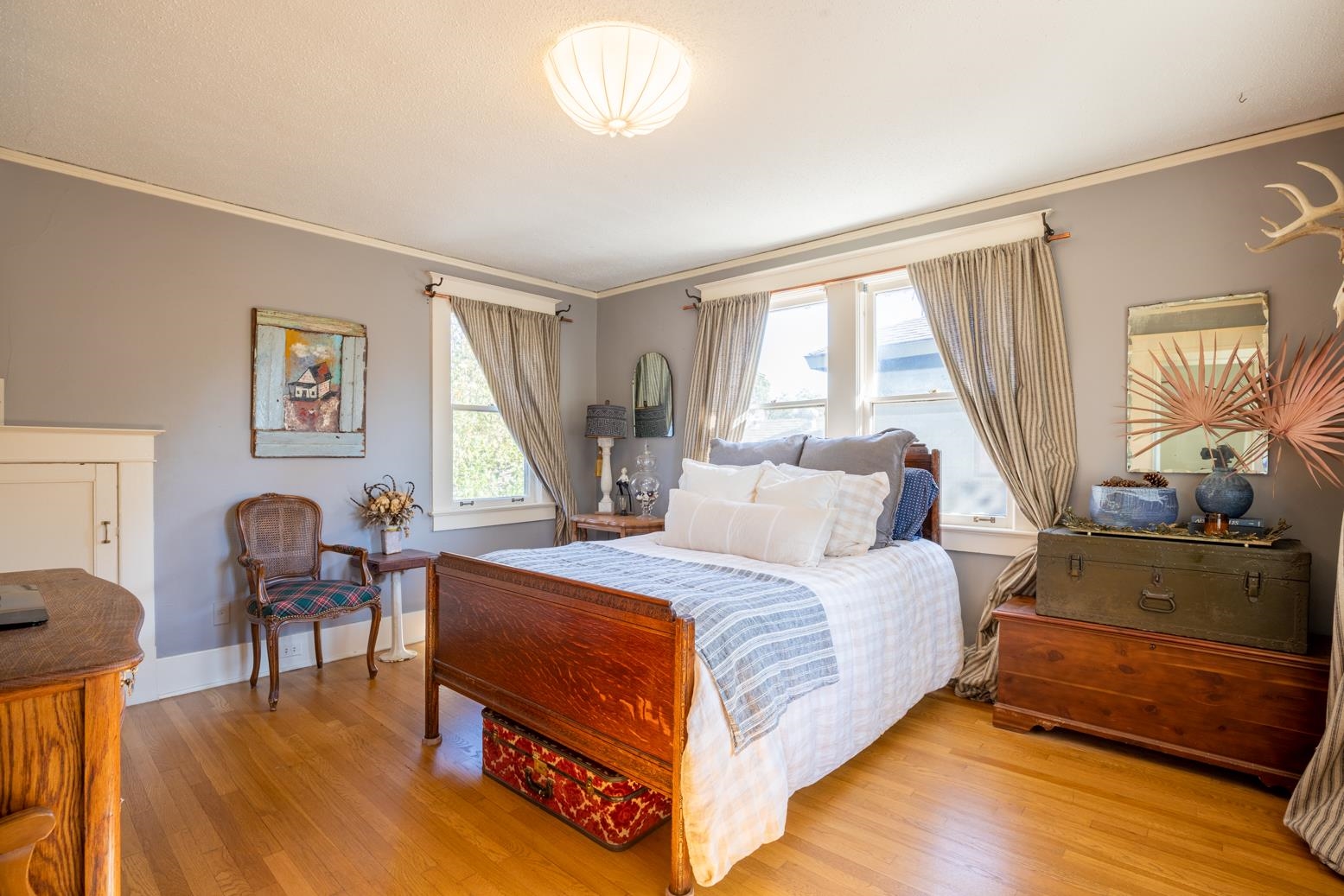 Upstairs Bedroom featuring light hardwood flooring, crown molding, and multiple windows