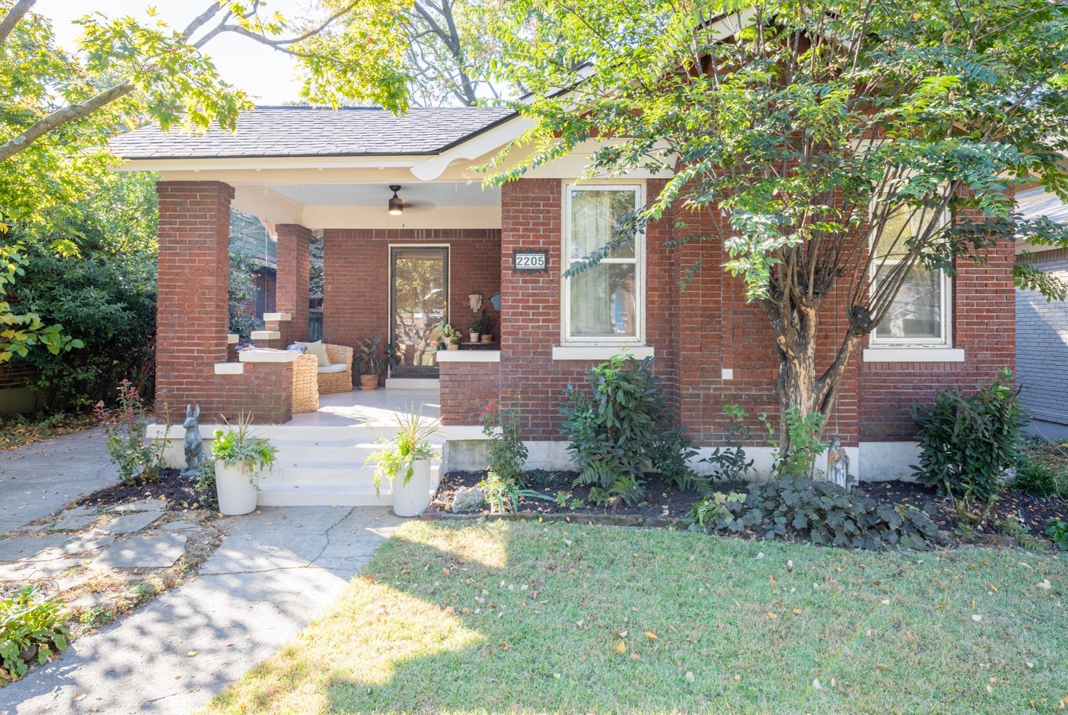 View of front of house featuring a front yard and covered porch