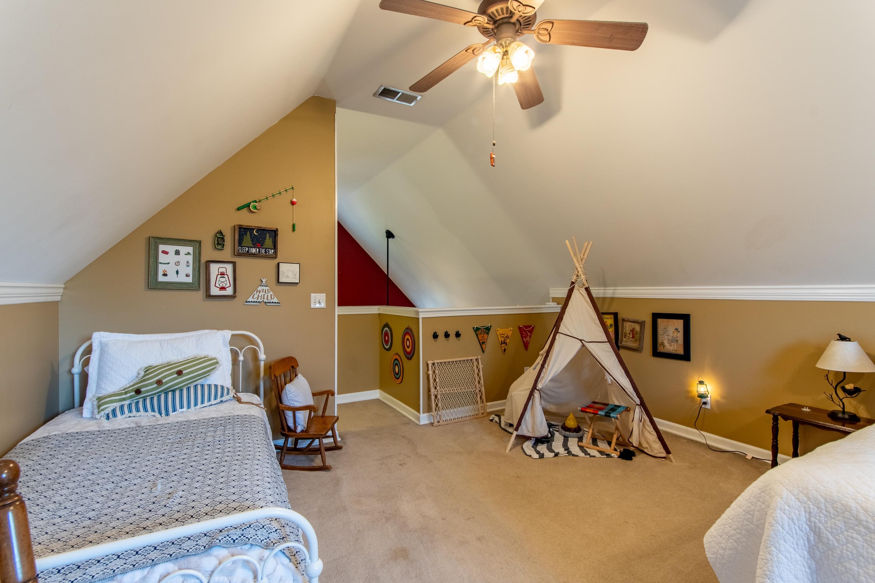 Bedroom featuring lofted ceiling, light colored carpet, crown molding, and ceiling fan