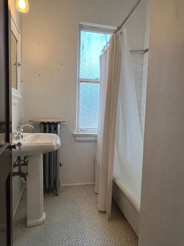 Bathroom with shower / bath combo with shower curtain and tile patterned flooring