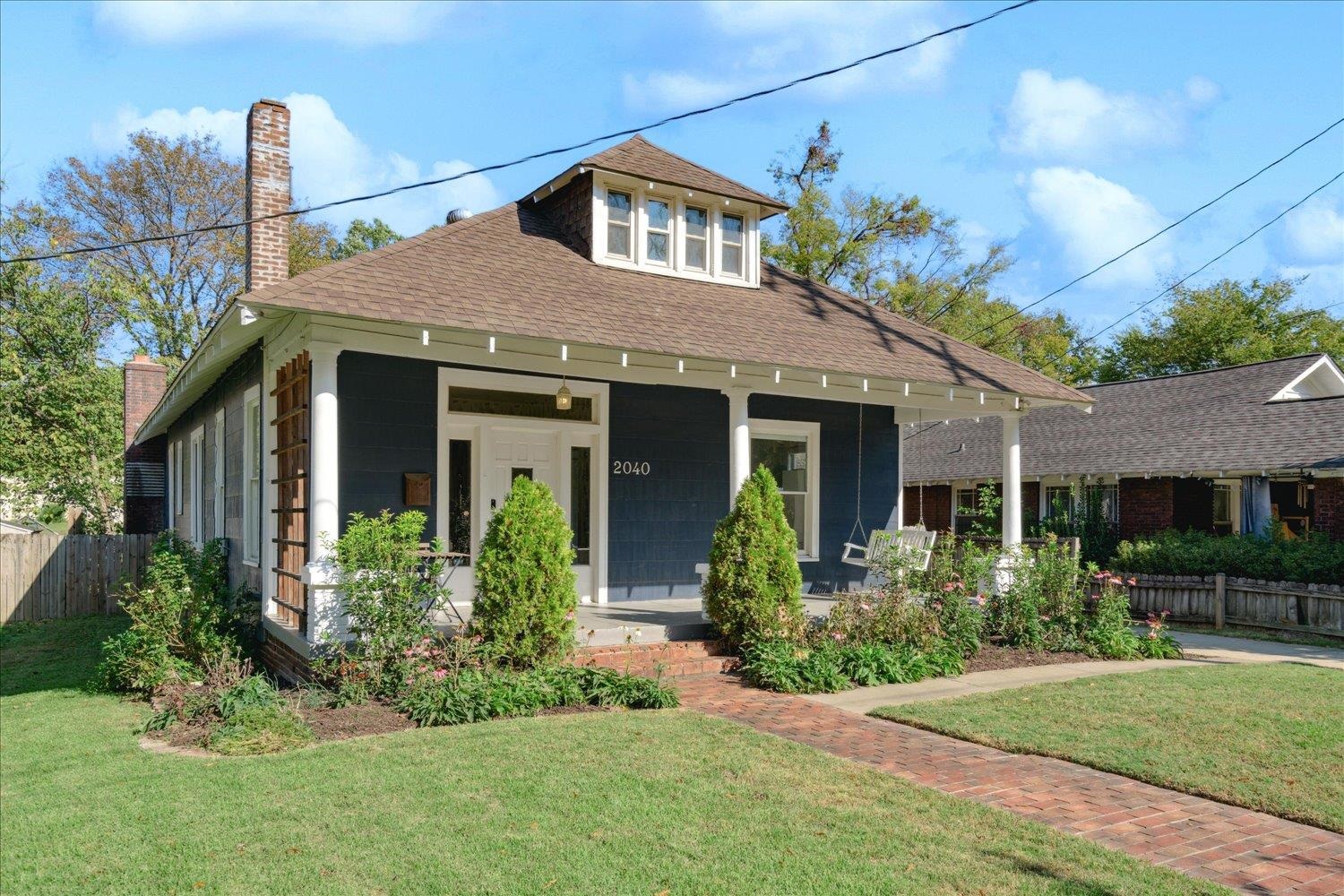 View of front of property with a front lawn and covered porch