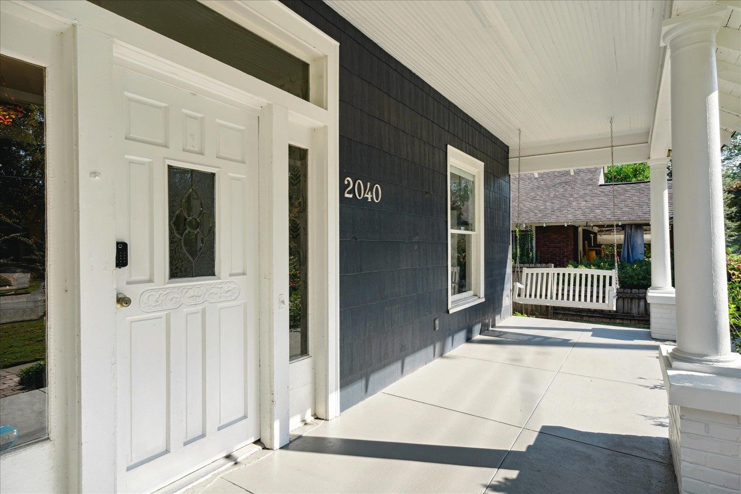 View of exterior entry with covered porch