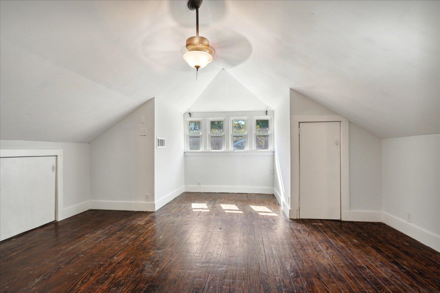 Additional living space featuring ceiling fan, vaulted ceiling, and dark hardwood / wood-style floors