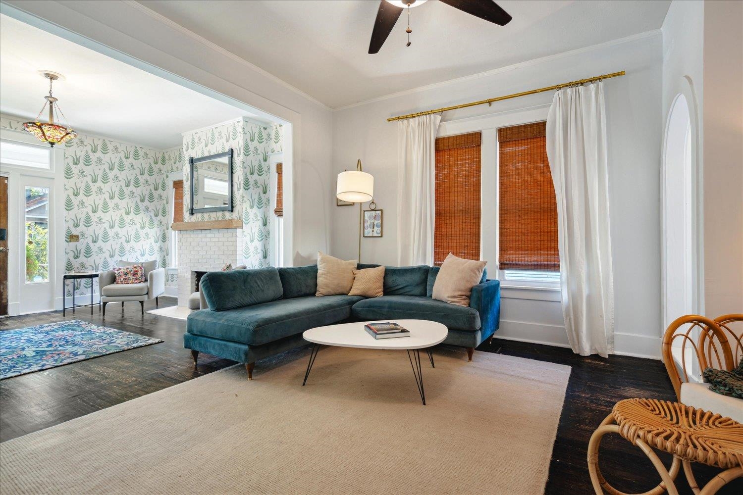 Living room featuring dark hardwood / wood-style floors, a fireplace, and ceiling fan