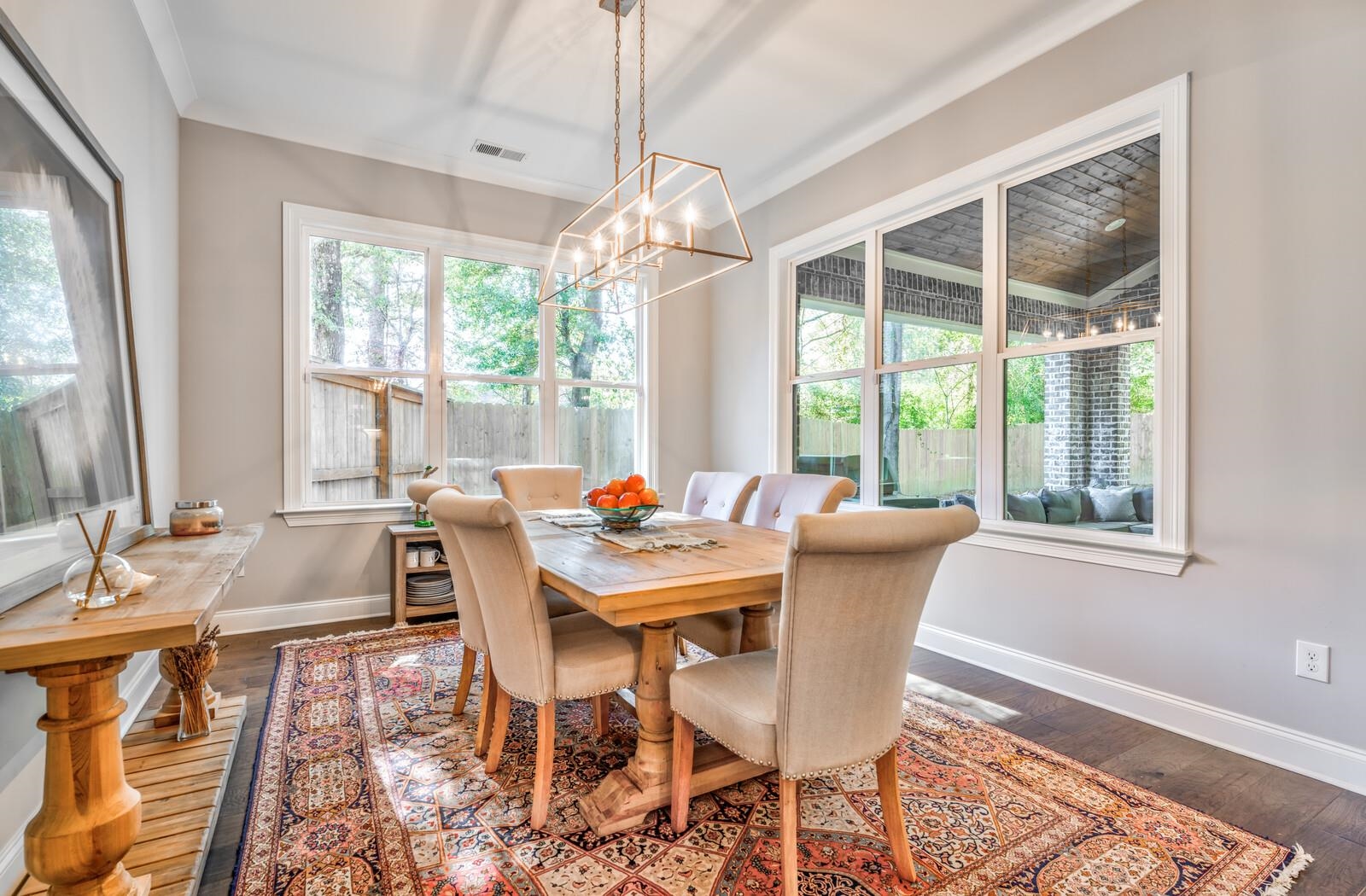 Dining area with crown molding, an inviting chandelier, and dark hardwood / wood-style flooring