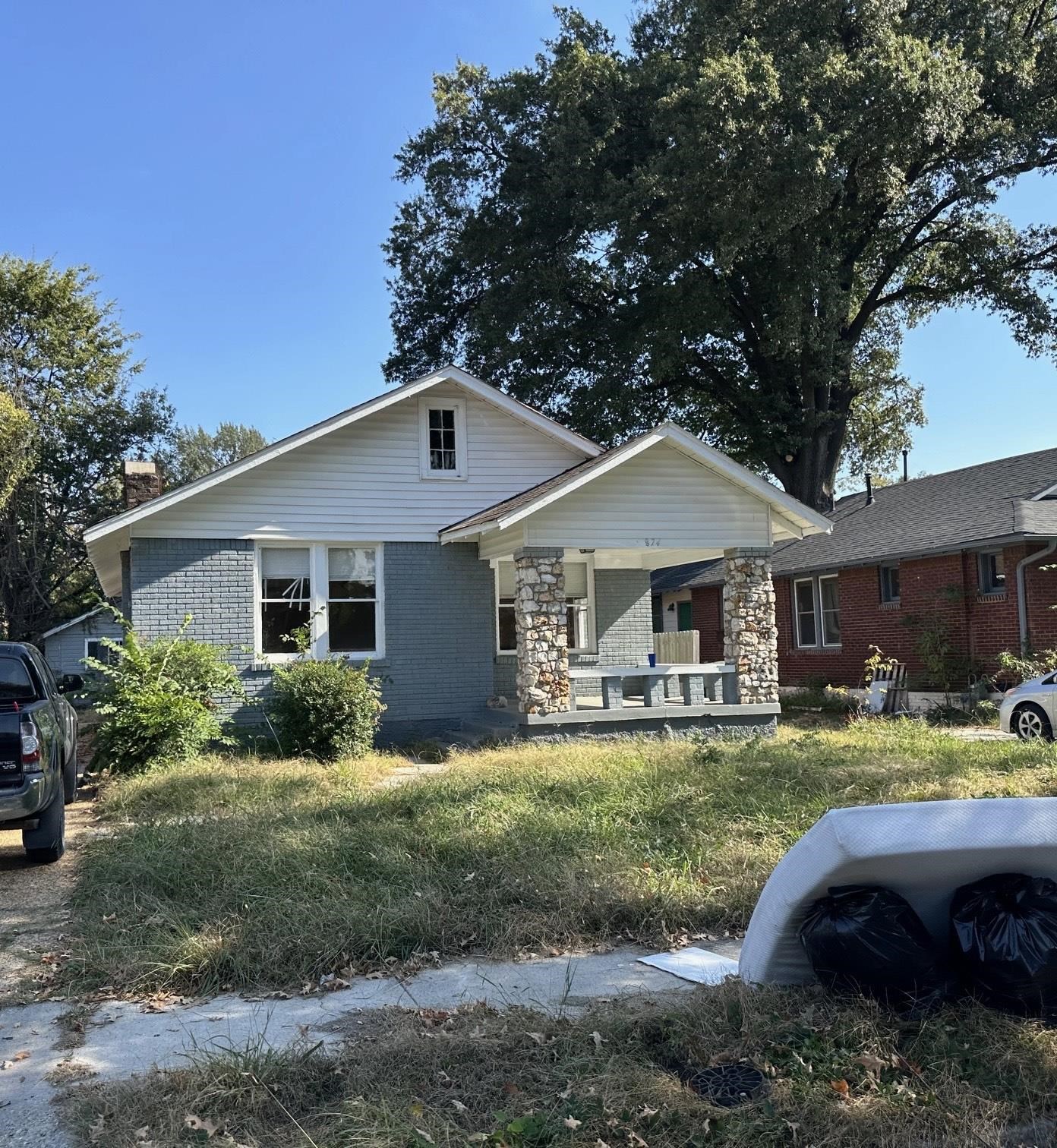View of front of house with covered porch and a front lawn