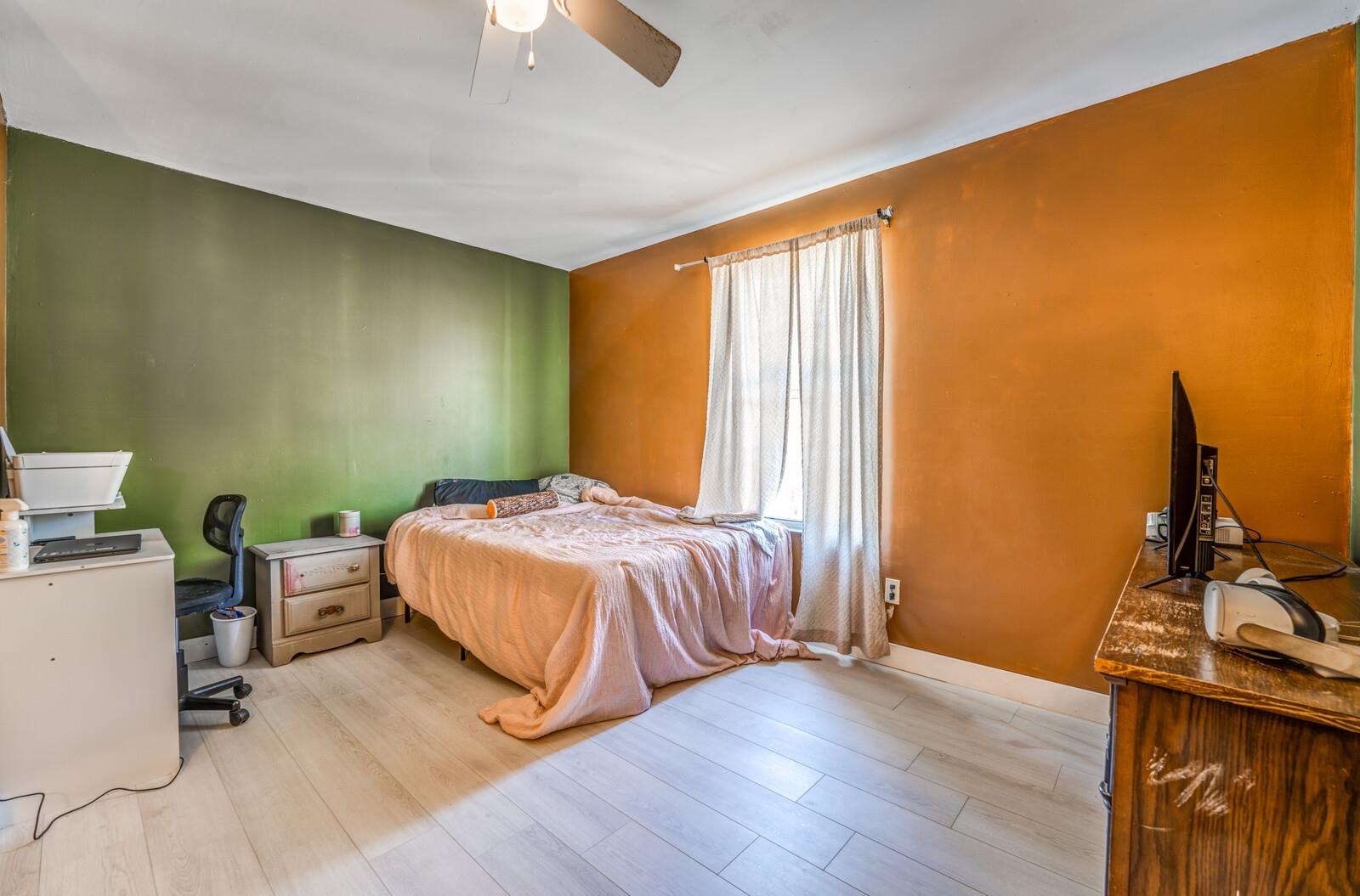 Bedroom featuring light hardwood / wood-style floors and ceiling fan