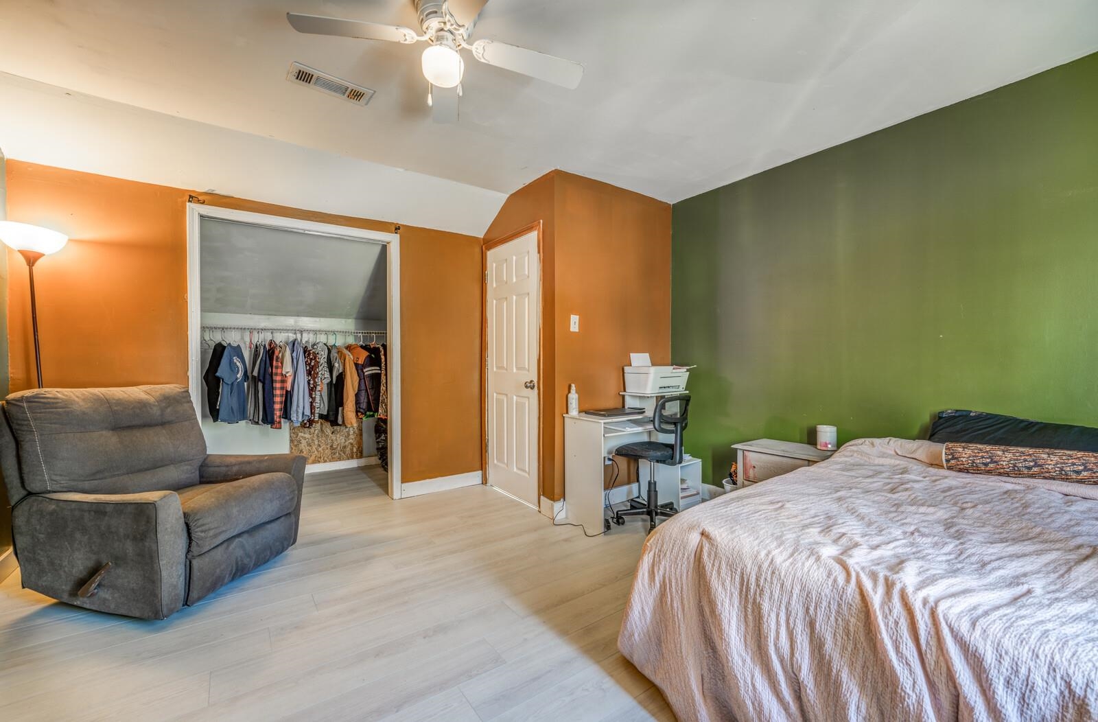 Bedroom with a closet, light wood-type flooring, and ceiling fan