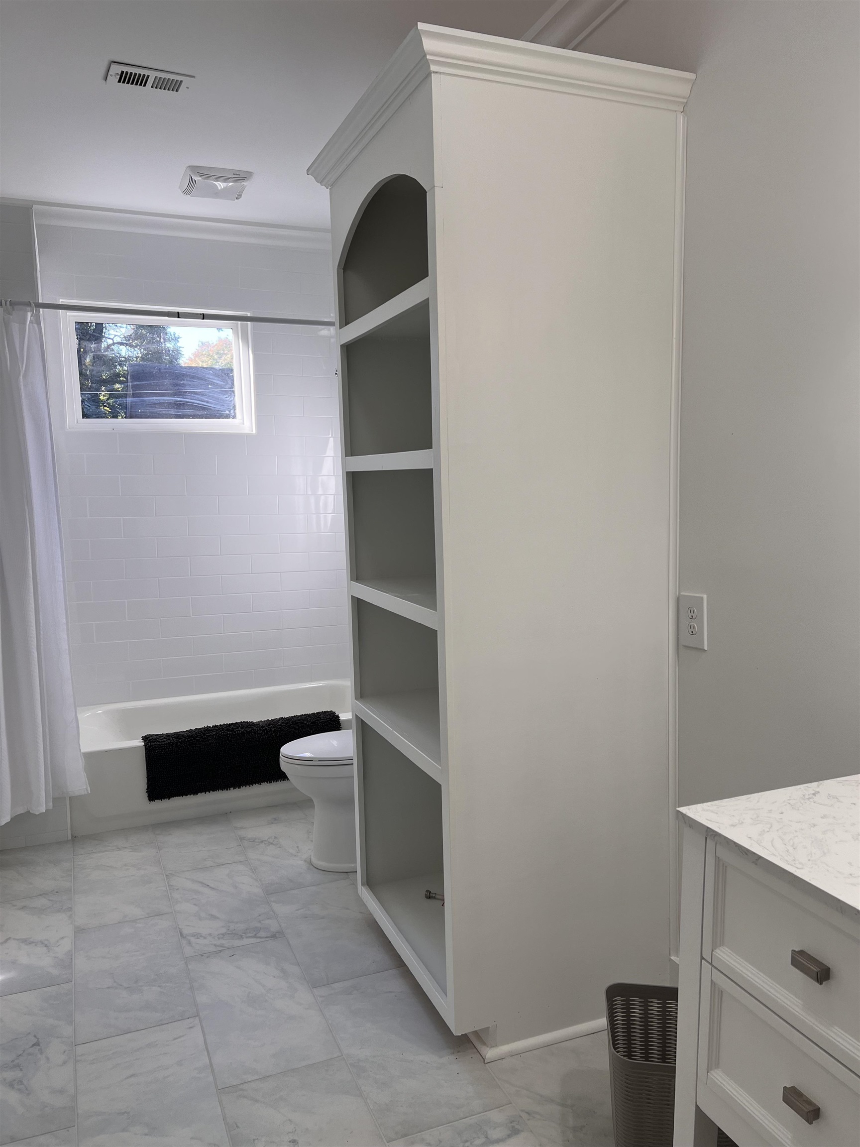 Full bathroom featuring vanity, shower / tub combo, crown molding, and toilet