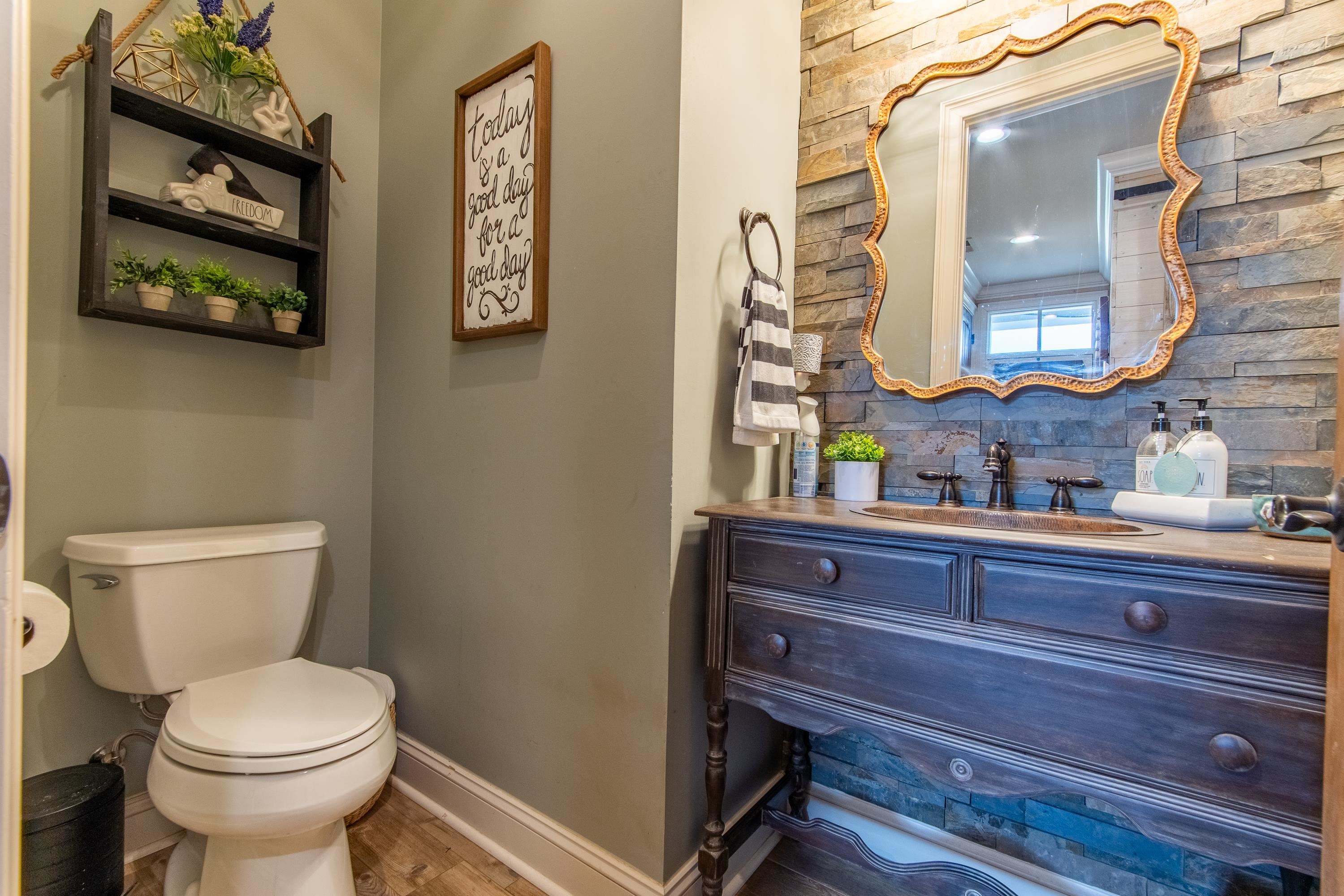 Bathroom featuring vanity, hardwood / wood-style floors, toilet, and tasteful backsplash