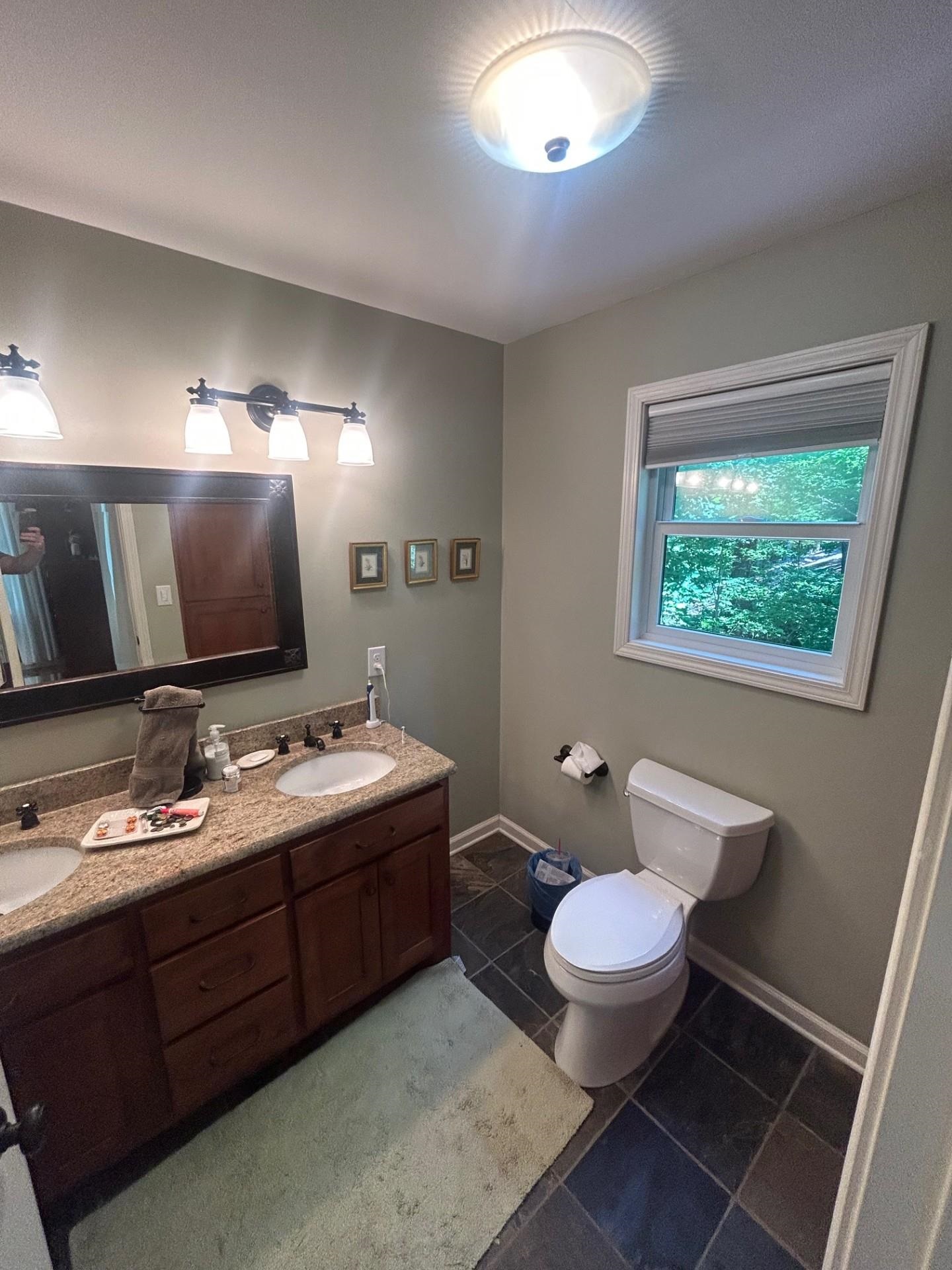 Bathroom with vanity, toilet, and tile patterned flooring