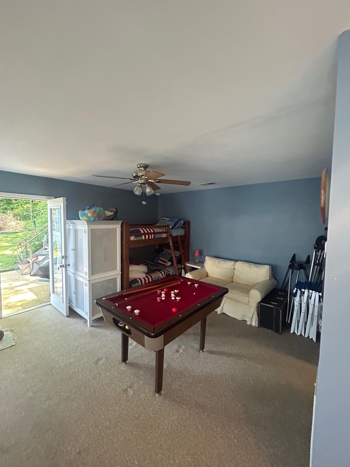 Game room with carpet flooring and ceiling fan