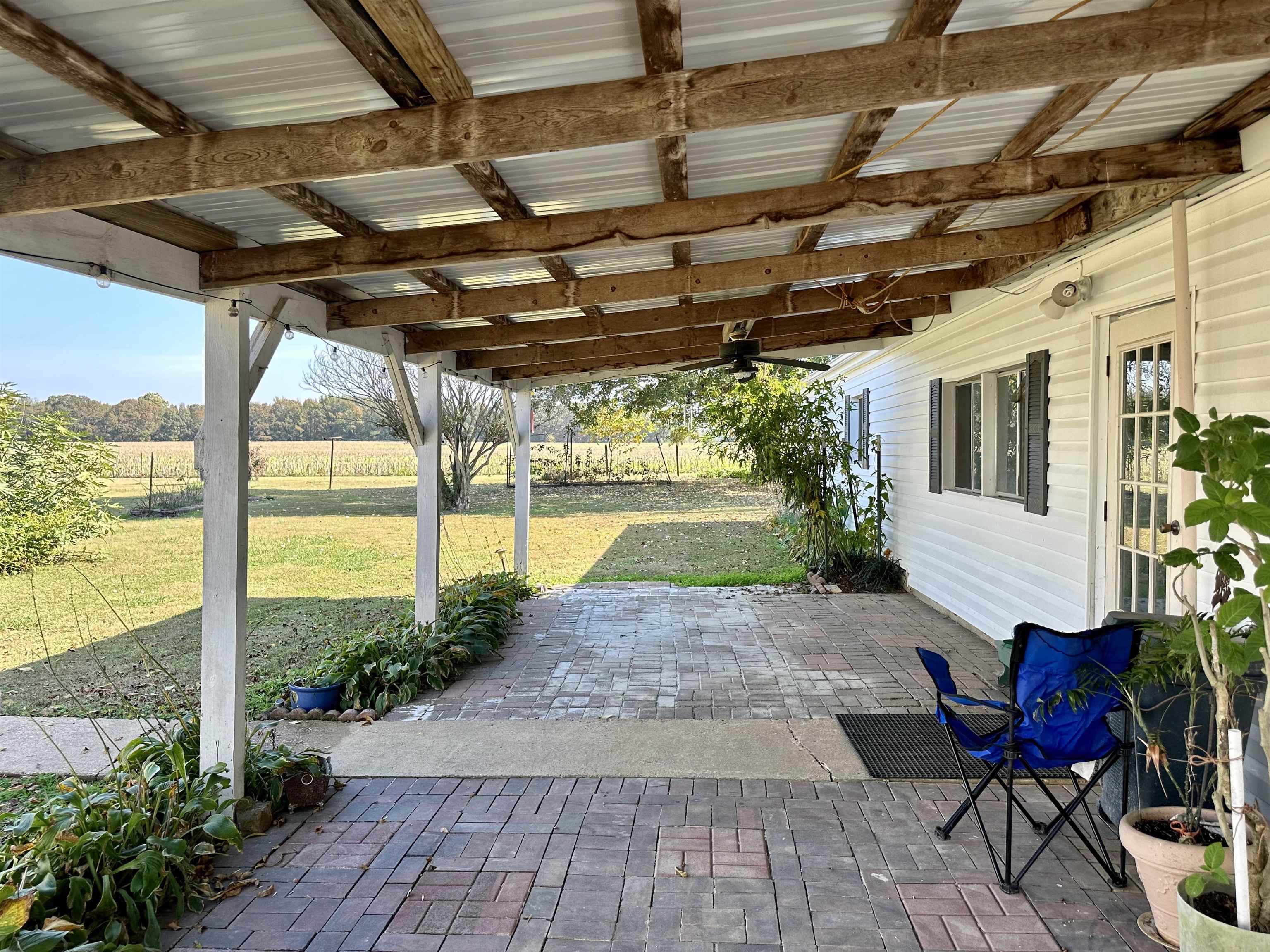 View of patio with a rural view and ceiling fan