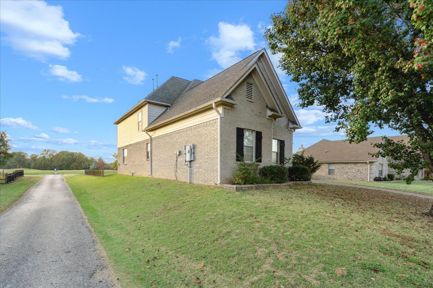 View of side of property featuring a lawn