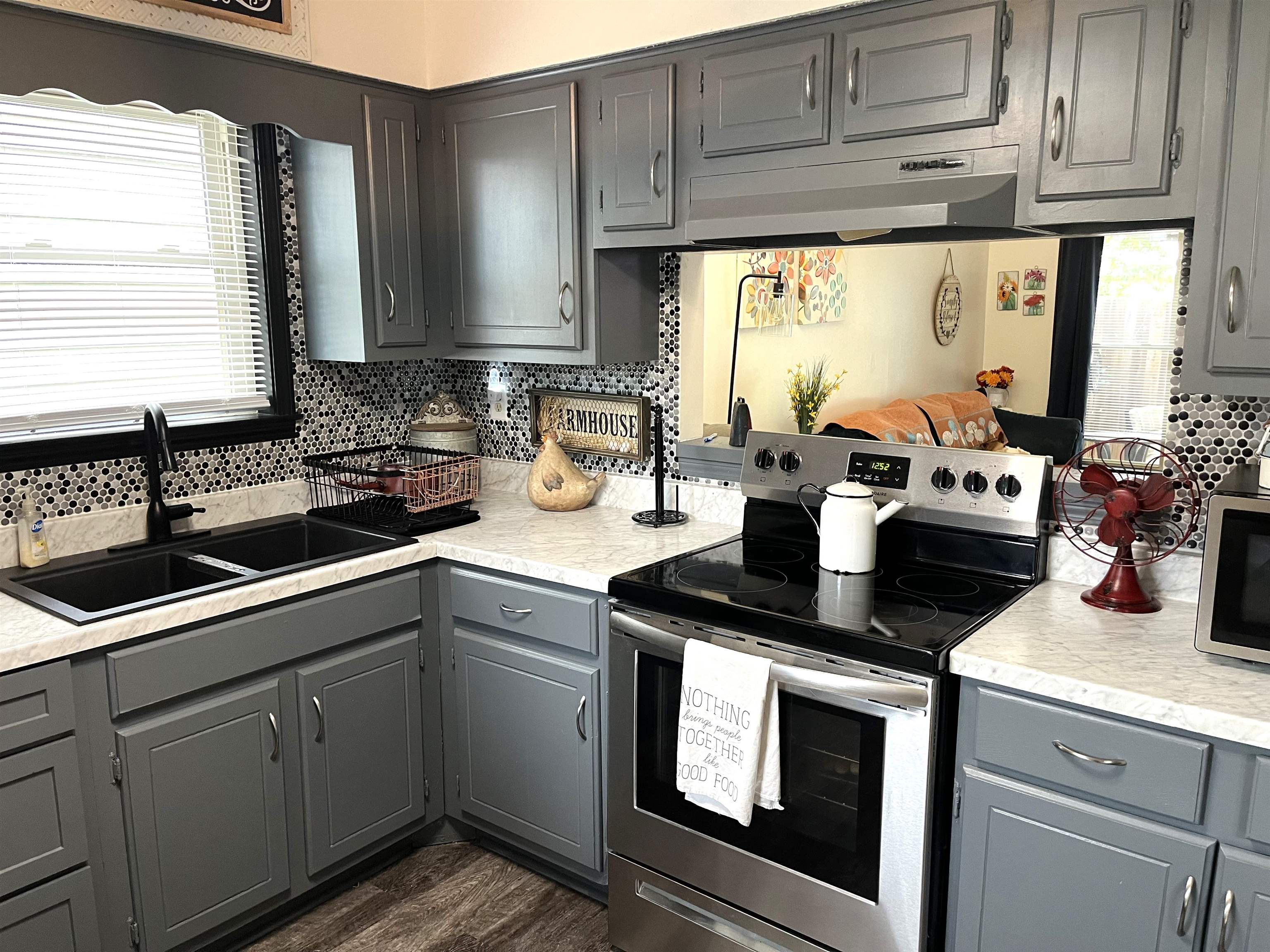 Kitchen with tasteful backsplash, stainless steel appliances, sink, and gray cabinetry