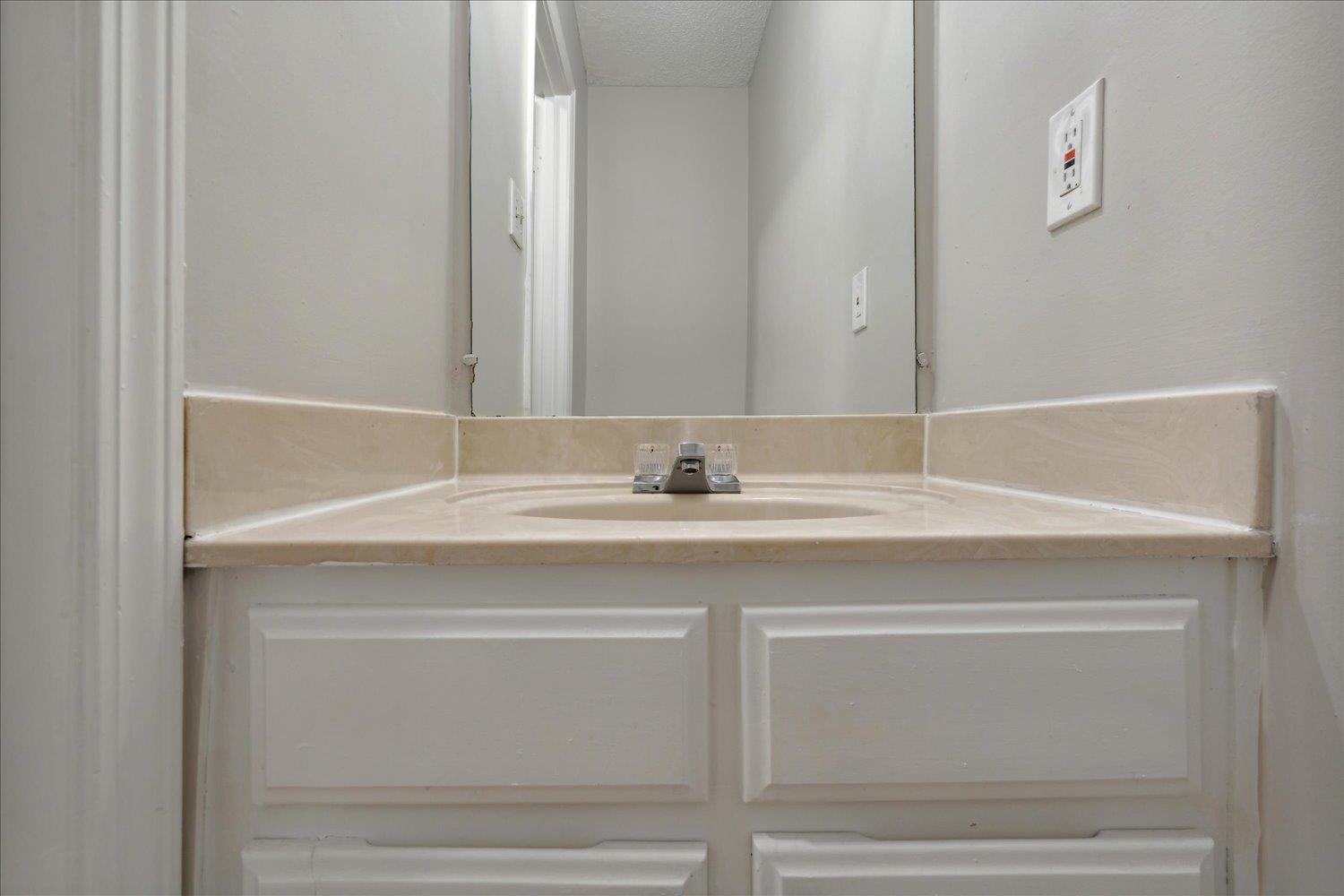 Bathroom featuring vanity and a textured ceiling