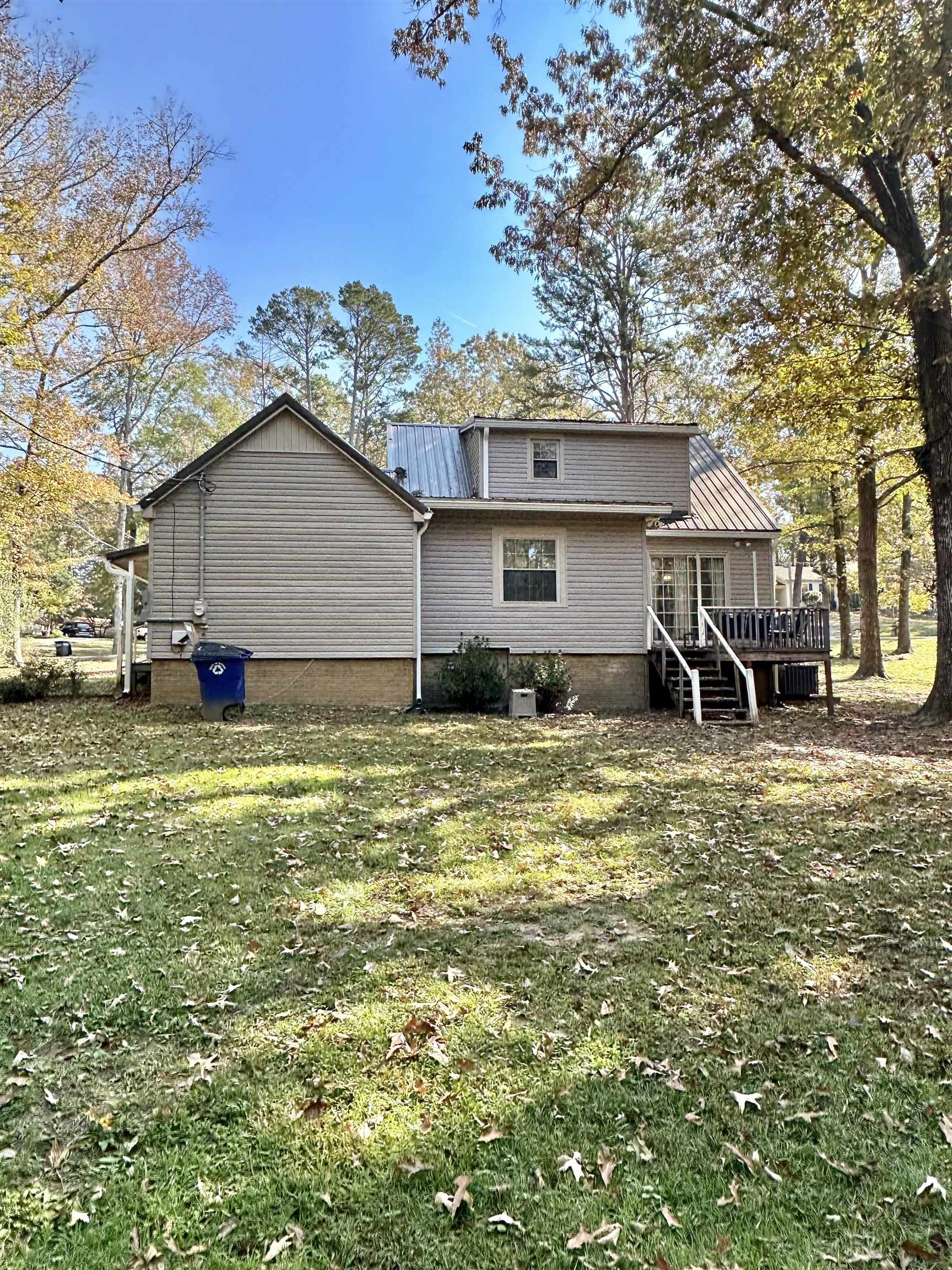 Rear view of house featuring a yard and a deck