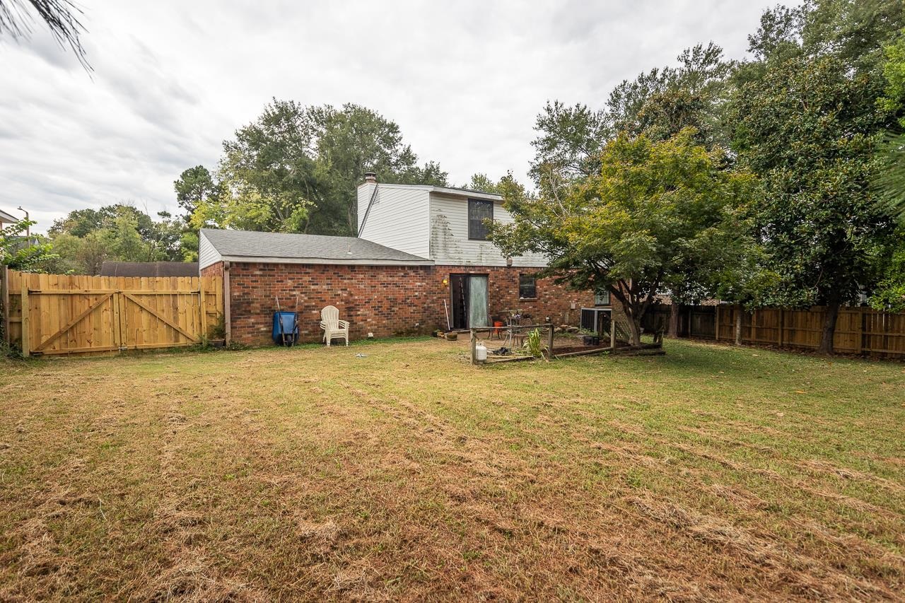 Back of property featuring a lawn