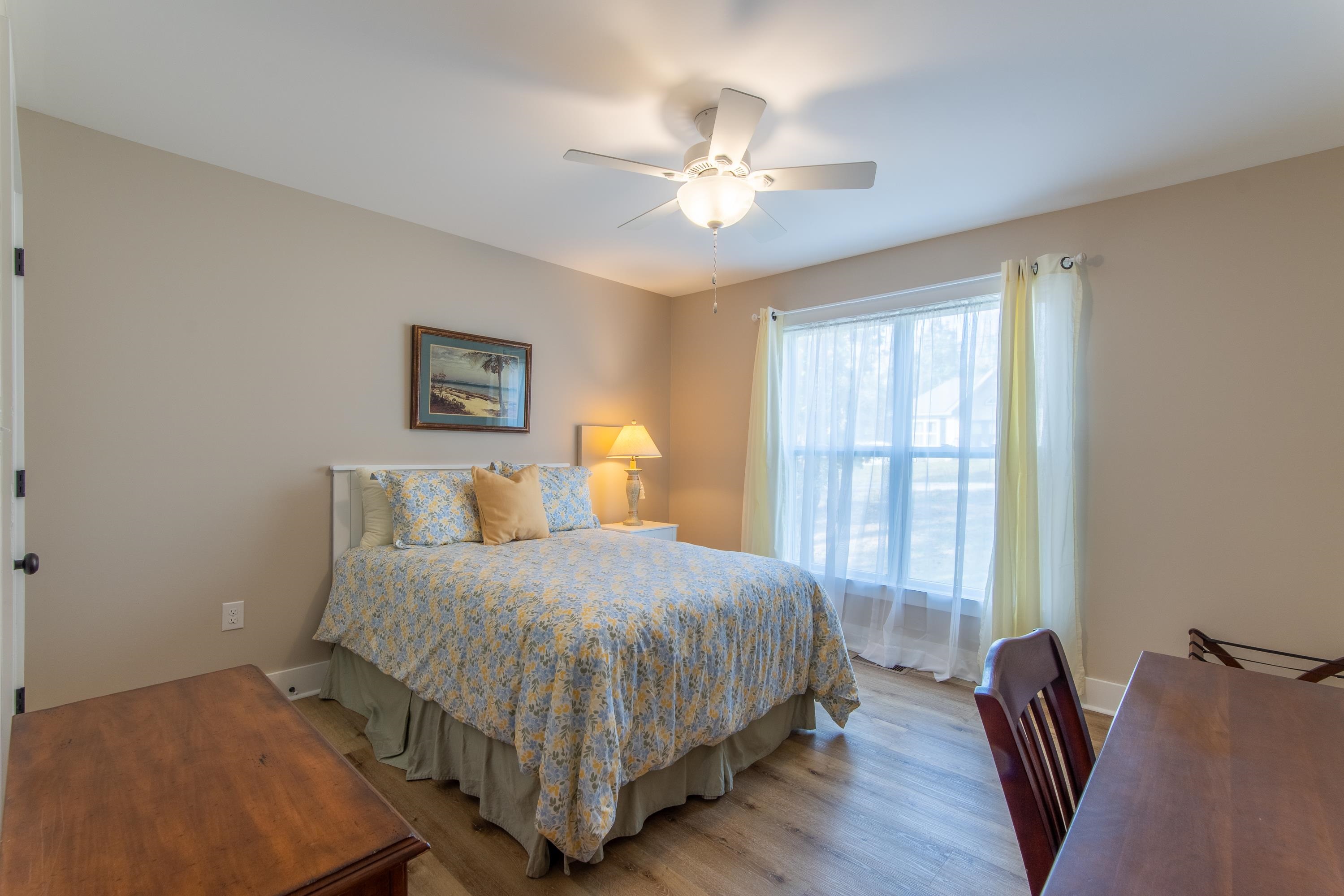 Bedroom with ceiling fan and light hardwood / wood-style flooring