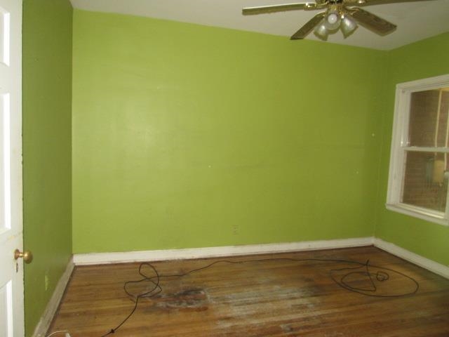 Unfurnished room with hardwood / wood-style floors and ceiling fan