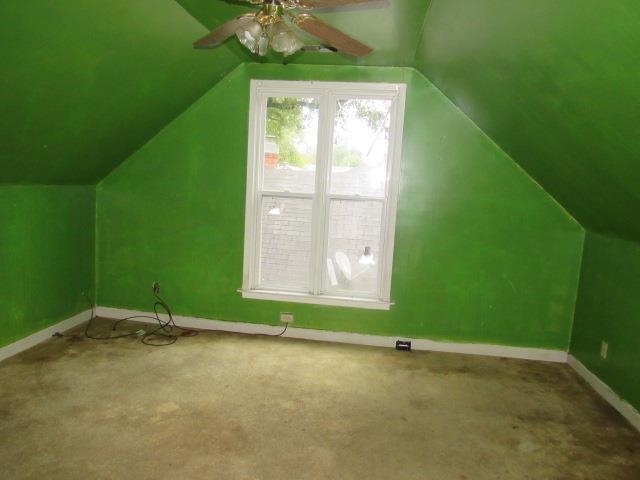 Bonus room featuring lofted ceiling, carpet flooring, and ceiling fan