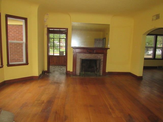 Unfurnished living room with dark hardwood / wood-style flooring