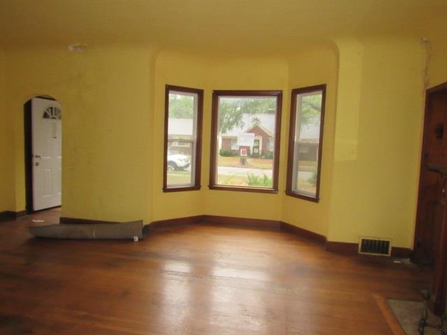 Unfurnished living room featuring hardwood / wood-style flooring