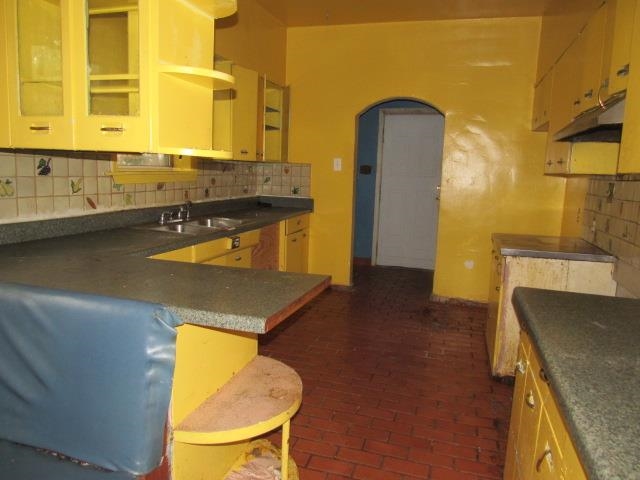 Kitchen featuring sink and decorative backsplash