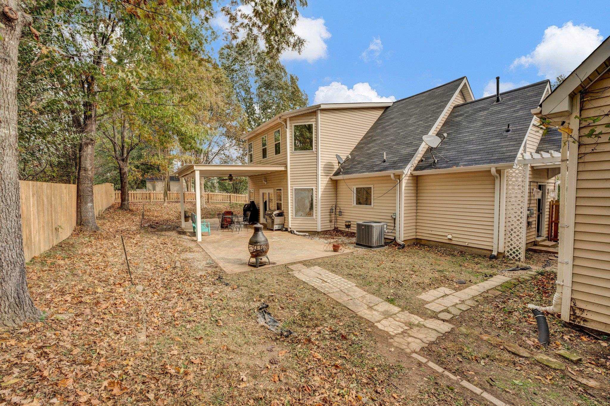 Rear view of property featuring central air condition unit and a patio area