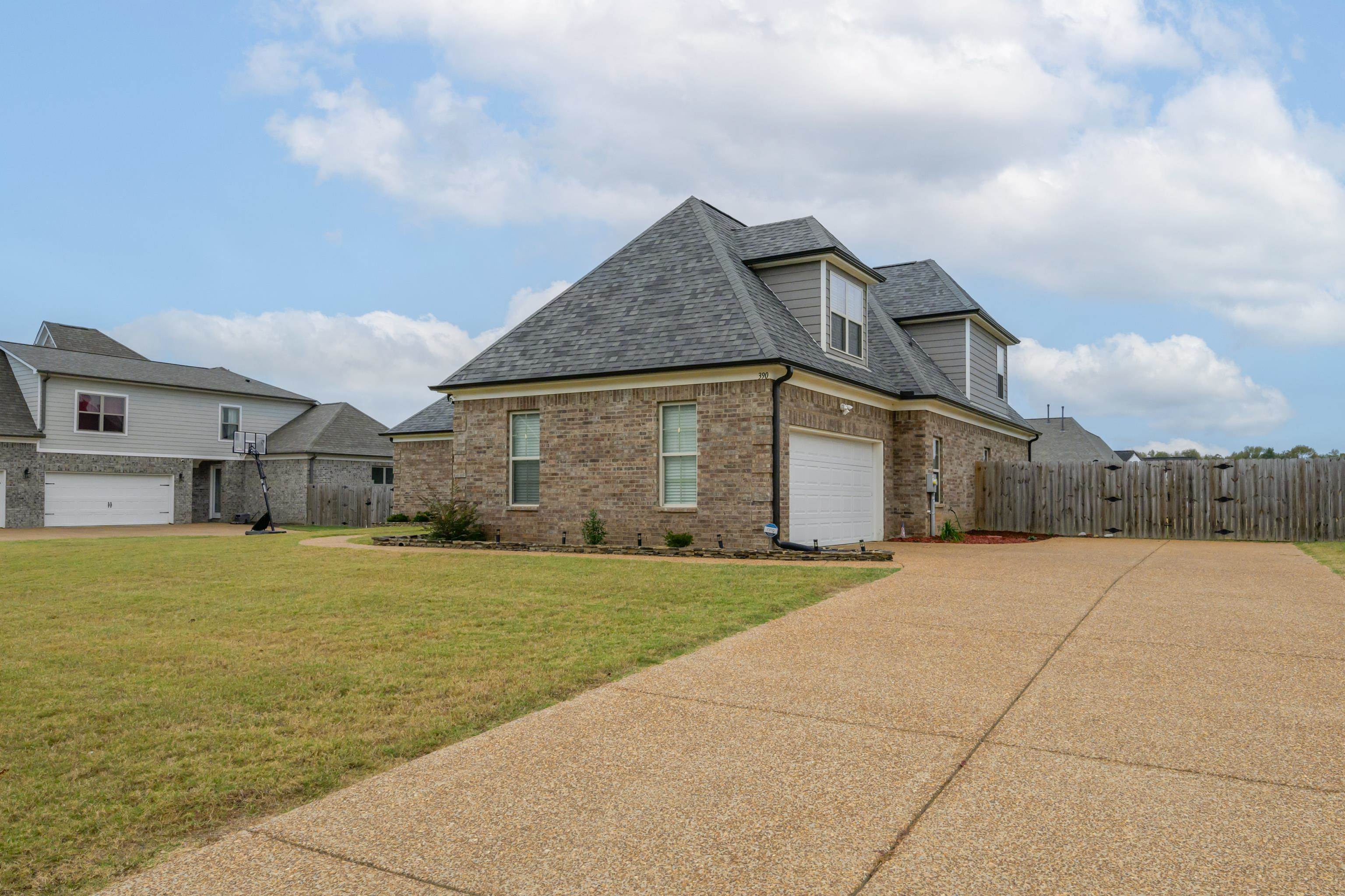 View of front of home with a garage and a front yard