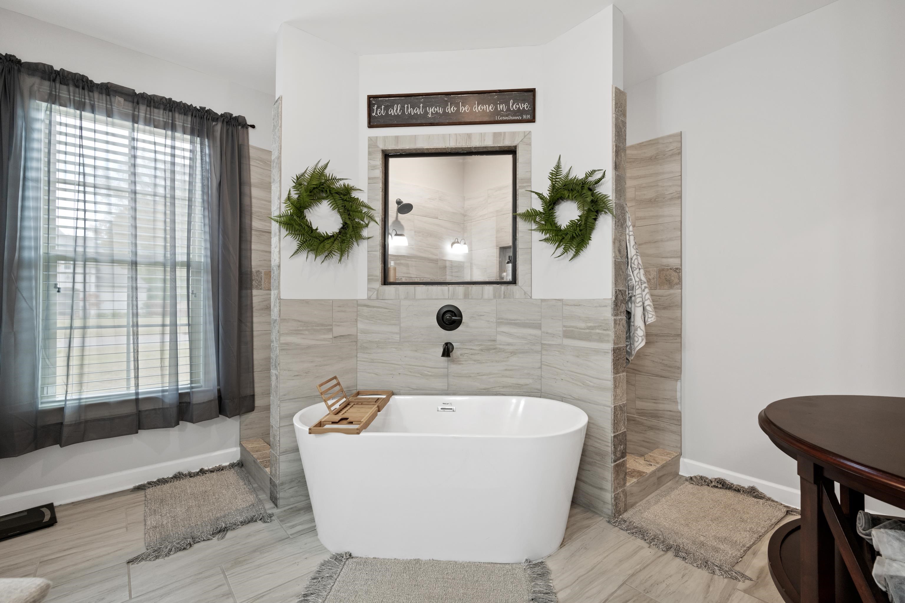 Bathroom featuring tile walls and shower with separate bathtub